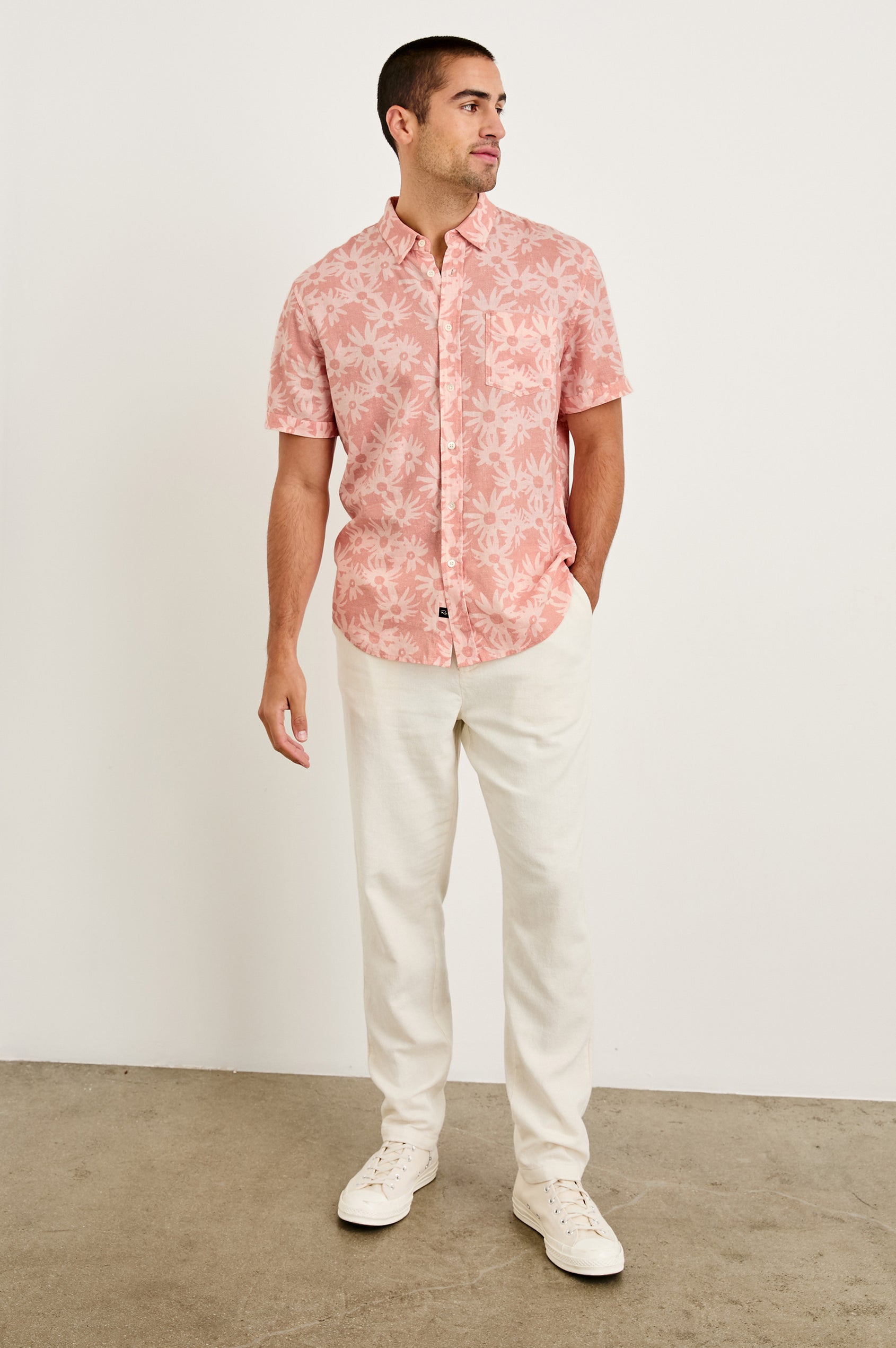 Carson linen short sleeve button down with a collar and floral pattern in Perennial Pink - full body front view on model