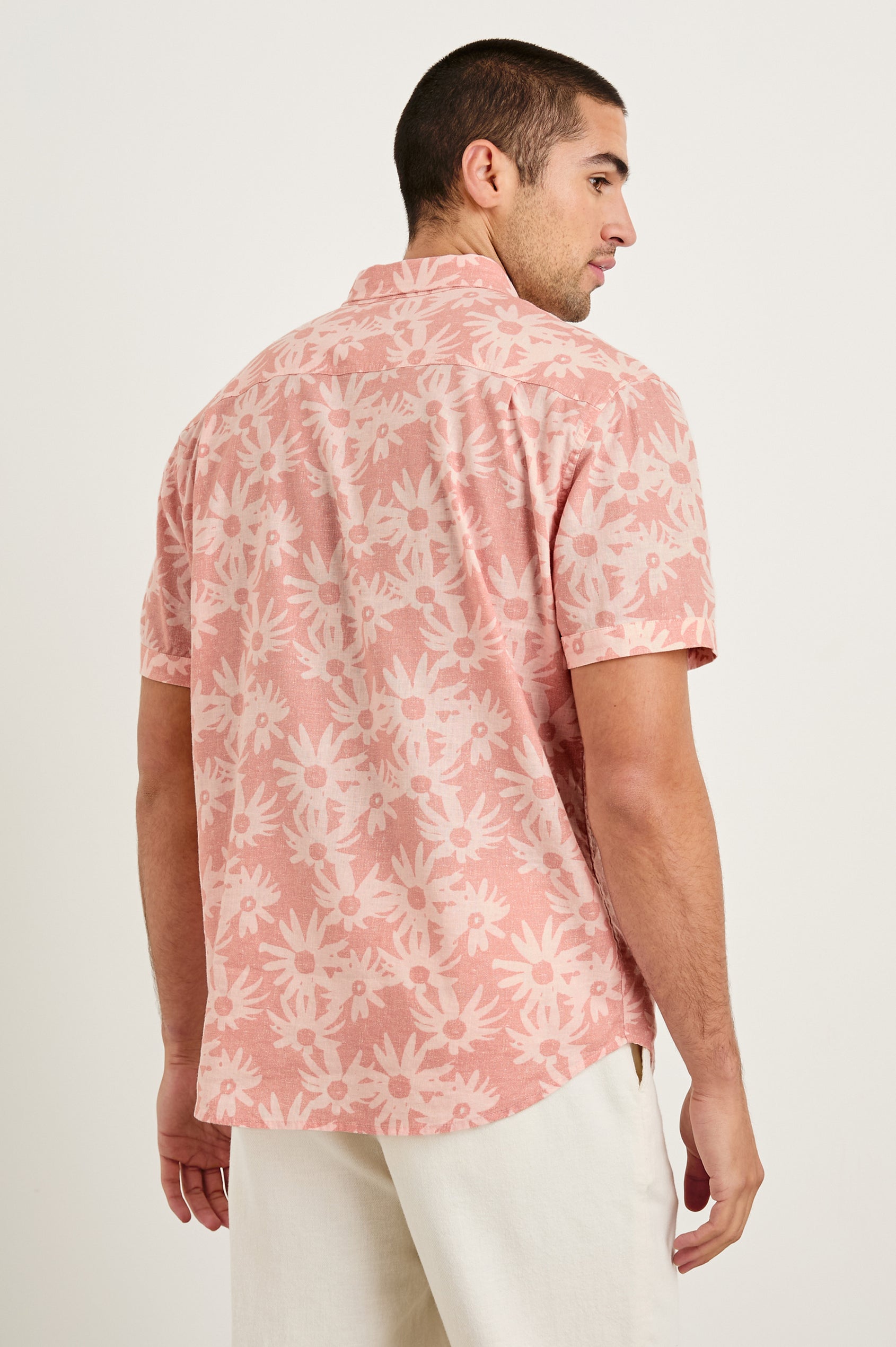 Carson linen short sleeve button down with a collar and floral pattern in Perennial Pink - back view on model