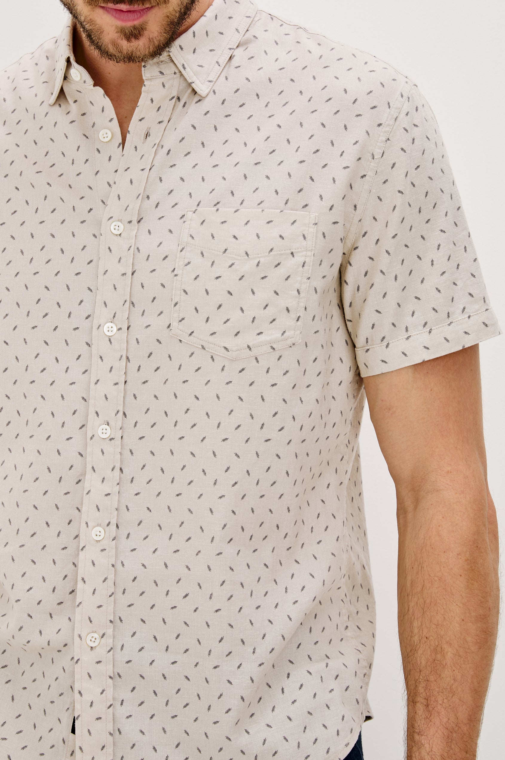 Carson linen short sleeve button down with a collar and front chest pocket in Petite Fronds Hummus colorway - front detail view on model