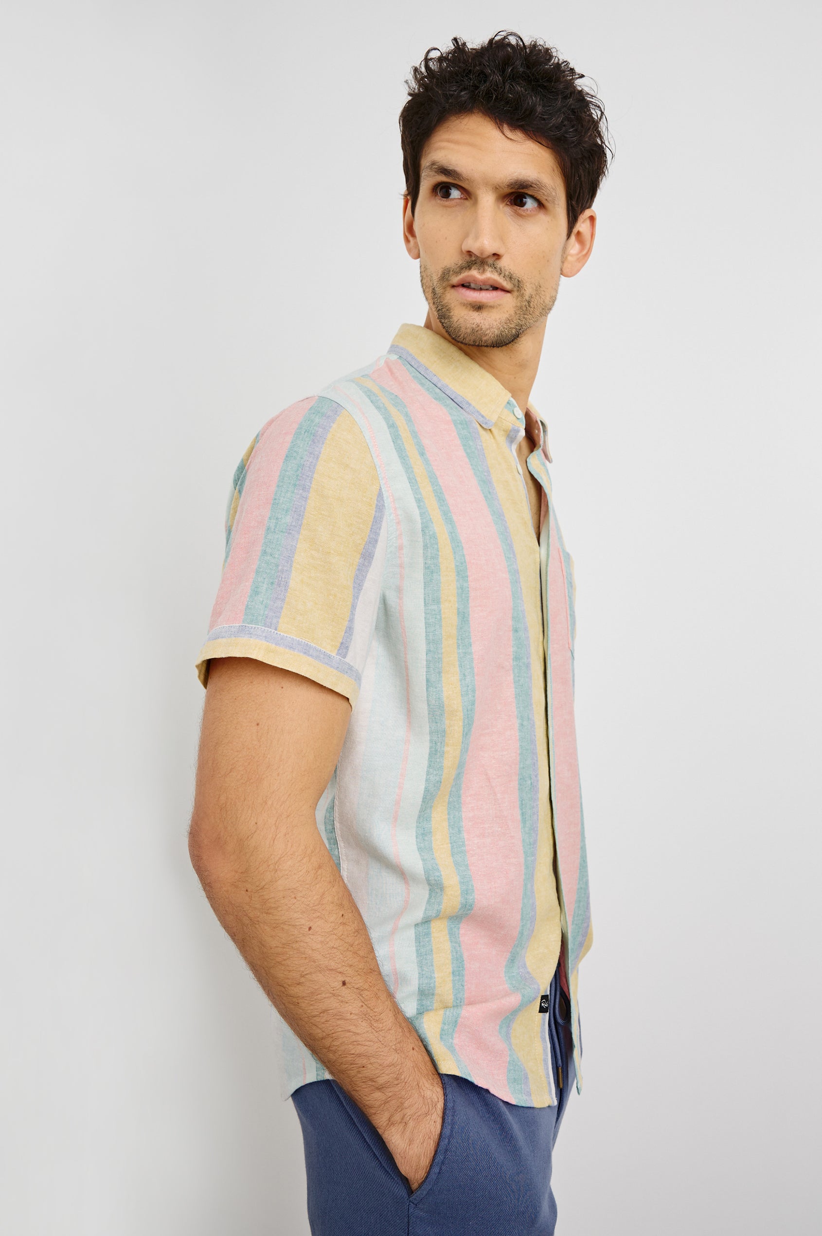 Carson Collared Button Front Shirt with Short Sleeves and a Chest Pocket in Portofino Stripe Colorway. Side View Shown on Model.