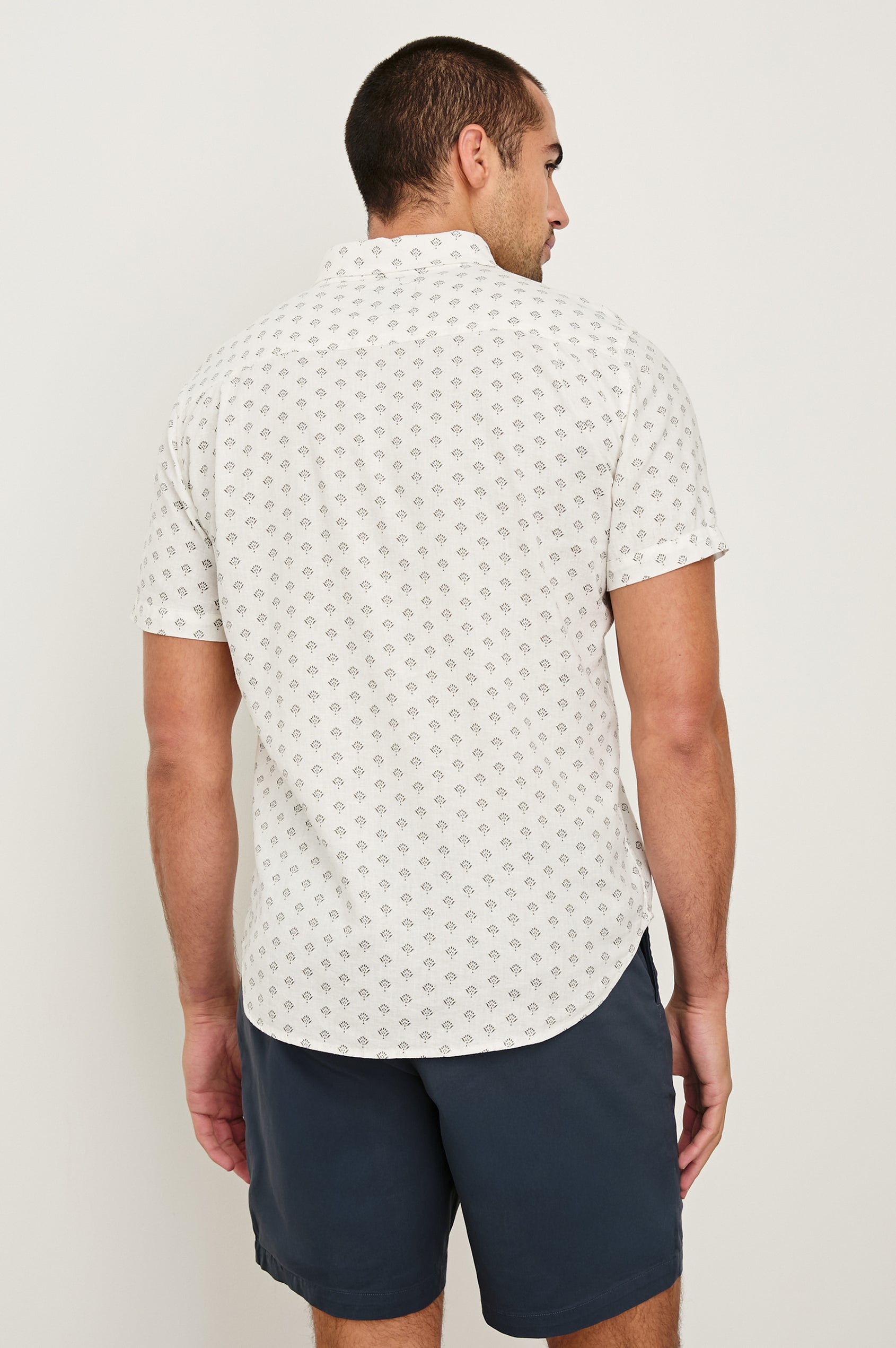 Carson linen short sleeve button down with a collar in Small Batik White - back view on model