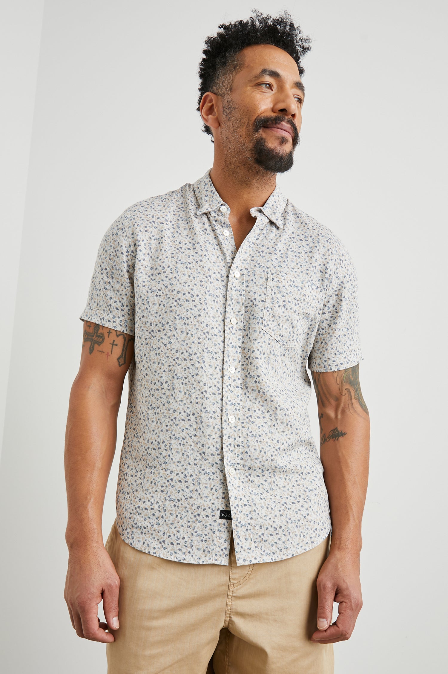 Carson Short Sleeve Button Up with a Chest Patch Pocket in Spring Blossom Parchment Colorway, Blossoms in Blue and Tan on Parchment - Front View Featured on Model