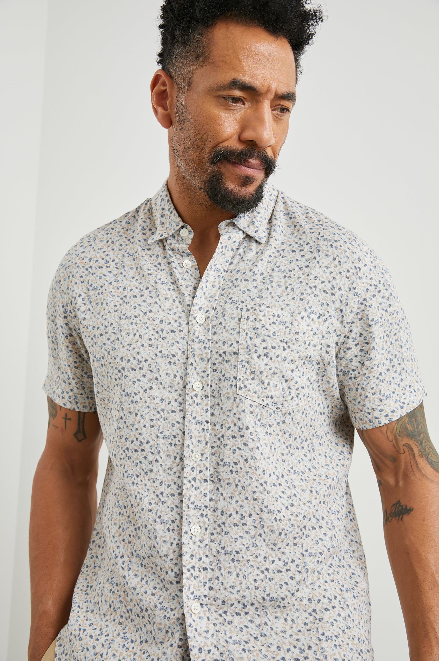 Carson Short Sleeve Button Up with a Chest Patch Pocket in Spring Blossom Parchment Colorway, Blossoms in Blue and Tan on Parchment - Front View Featured on Model