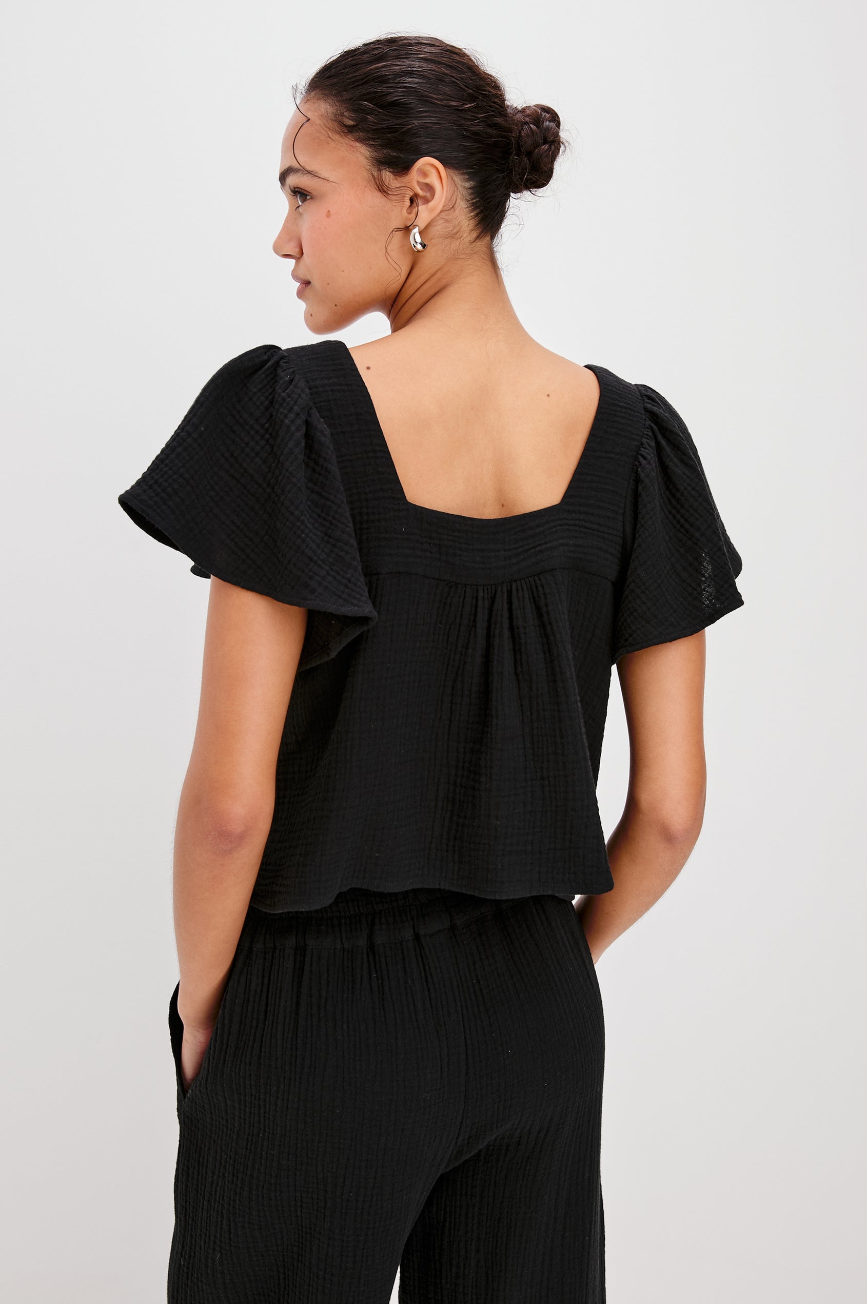 Casie Square Neck Top with Short Flutter Sleeves, V-Cut Center Front with Self Tie in Black Colorway. Back View Shown on Model.