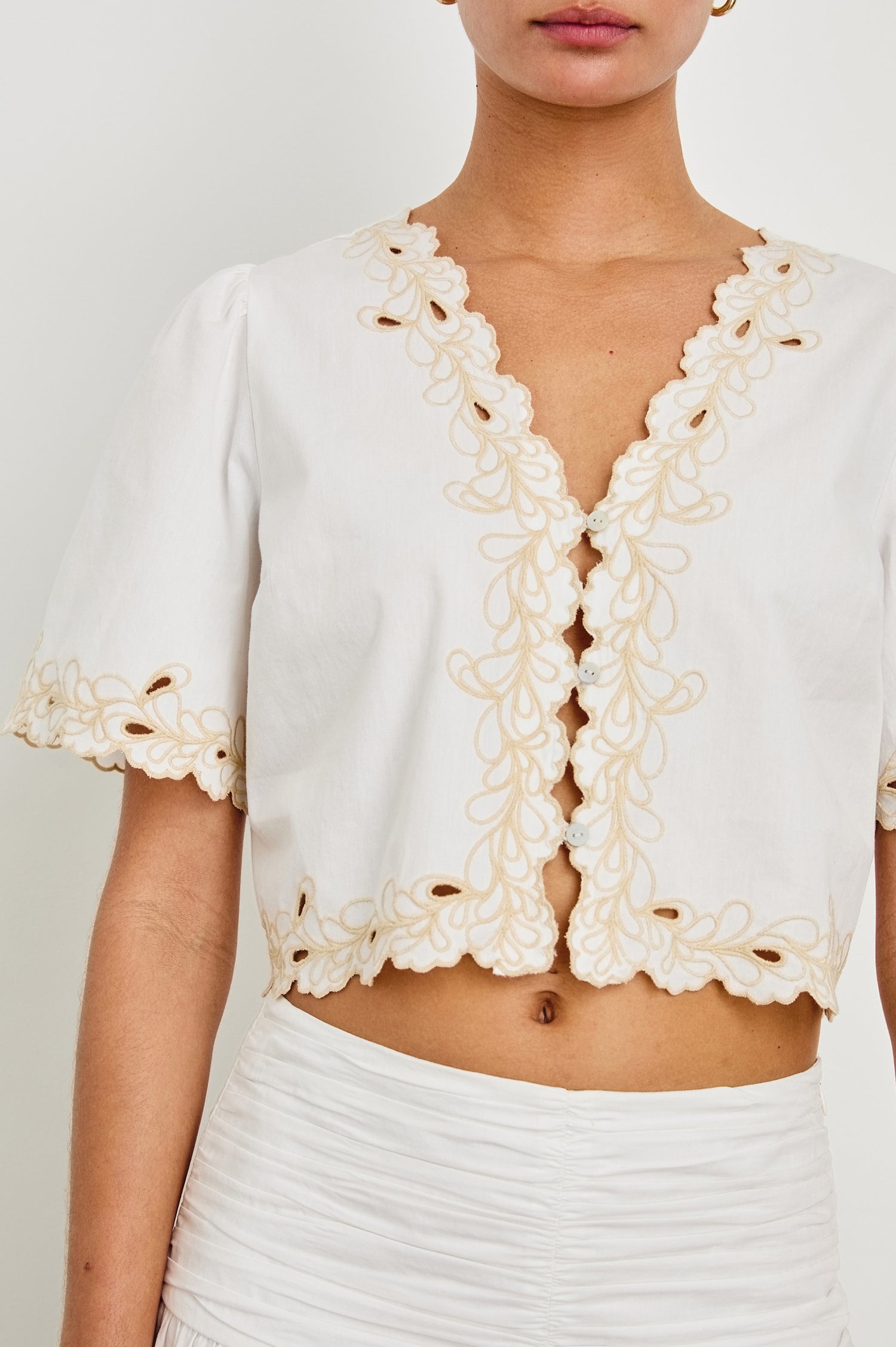 Cataluna white sleeveless top featuring intricate lace detailing and a scalloped hem - front view featured on model.