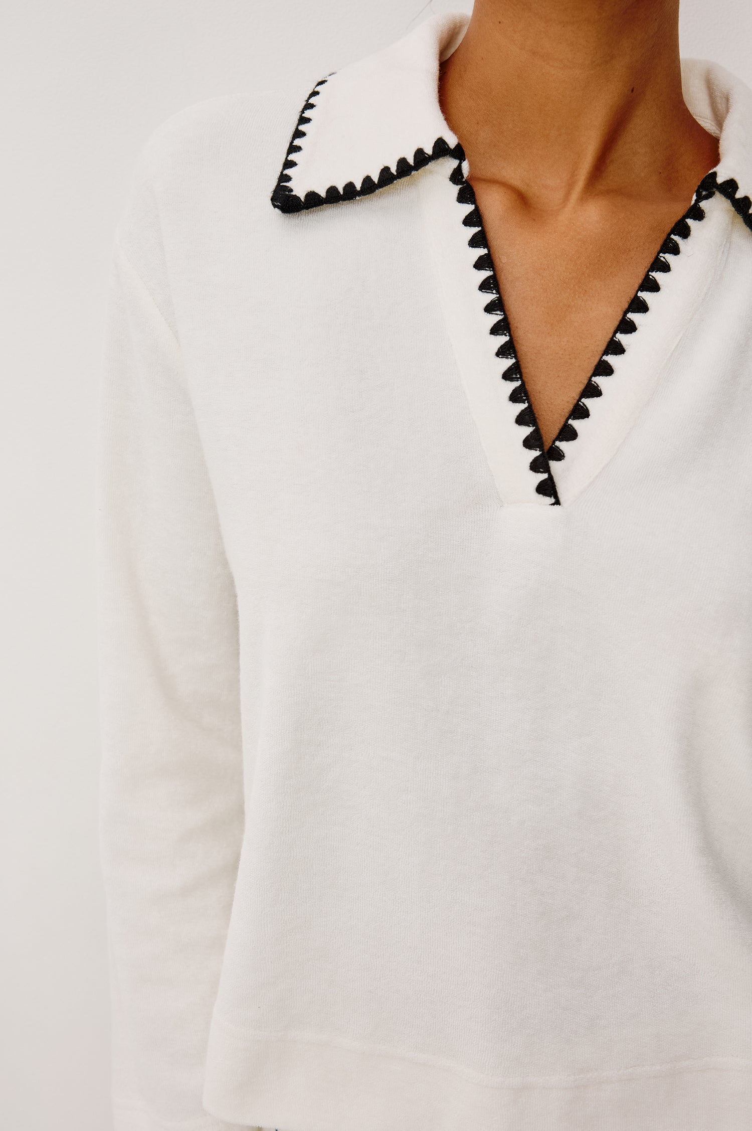 Cati Shirt in Terry With Collar, V-Neckline, Contrast Blanket Stitch Detailing, and Long Sleeves in Ivory Colorway - Upper Body Close Up Front View Featured on Model