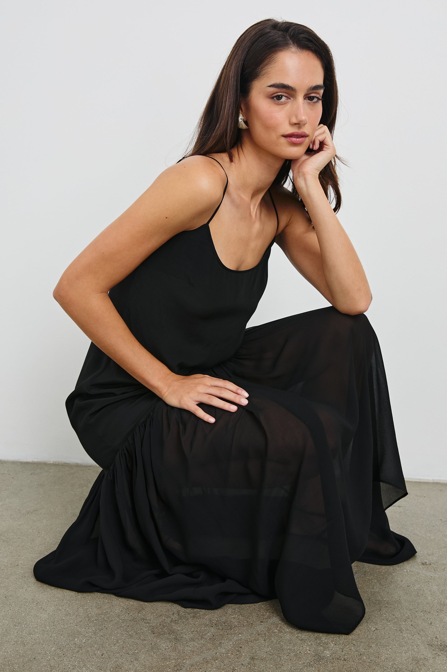 Chandra Maxi Tank Dress with Spaghetti Straps and a Contrast Semi Sheer Fabric Gathered Hem in Black Colorway. Front View Shown on Model.