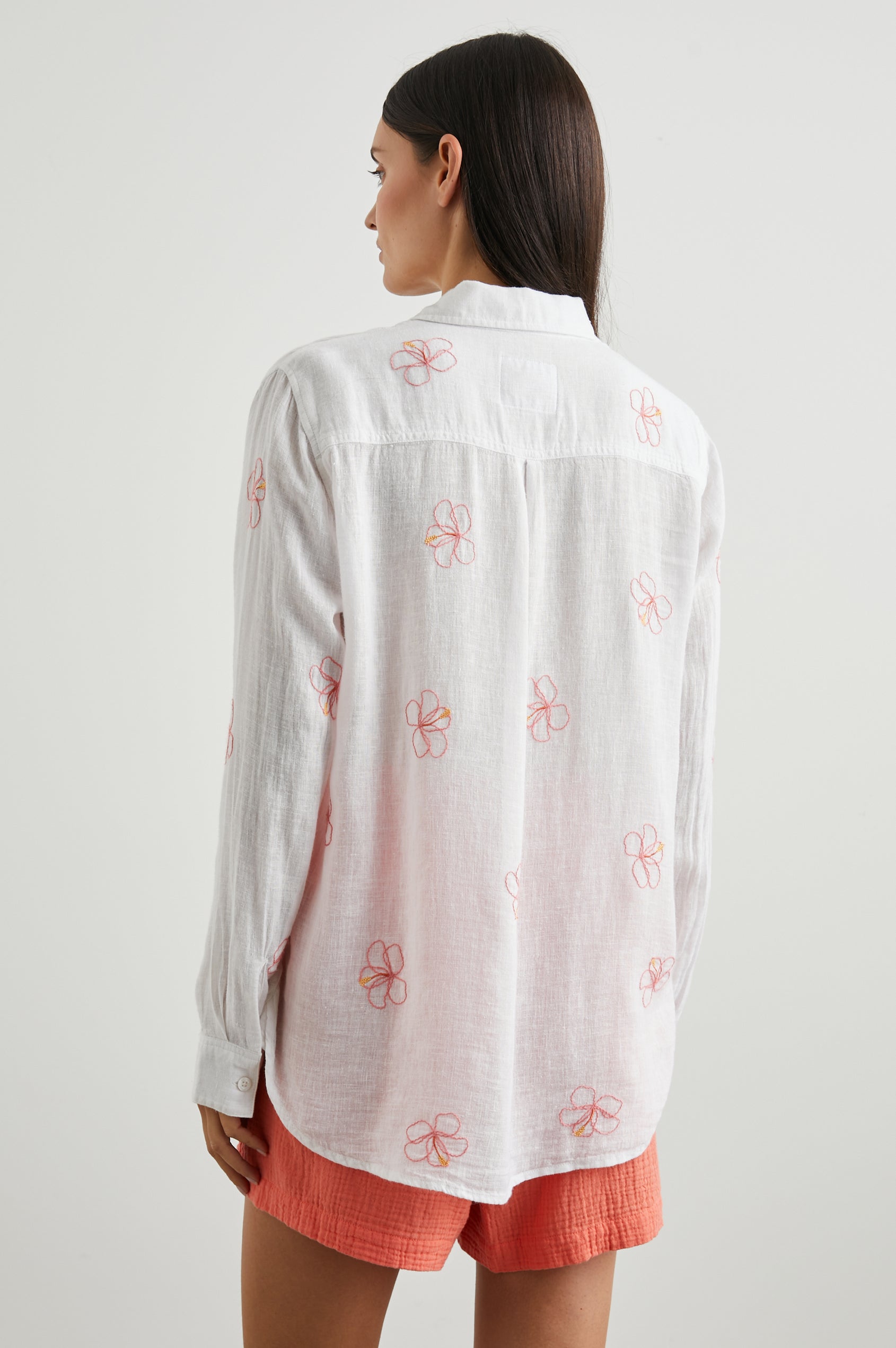Charli Long-Sleeve Button up with a Chest Patch Pocket in Hibiscus Embroidery Colorway, with Hibiscus on white  - Back View Featured on Model