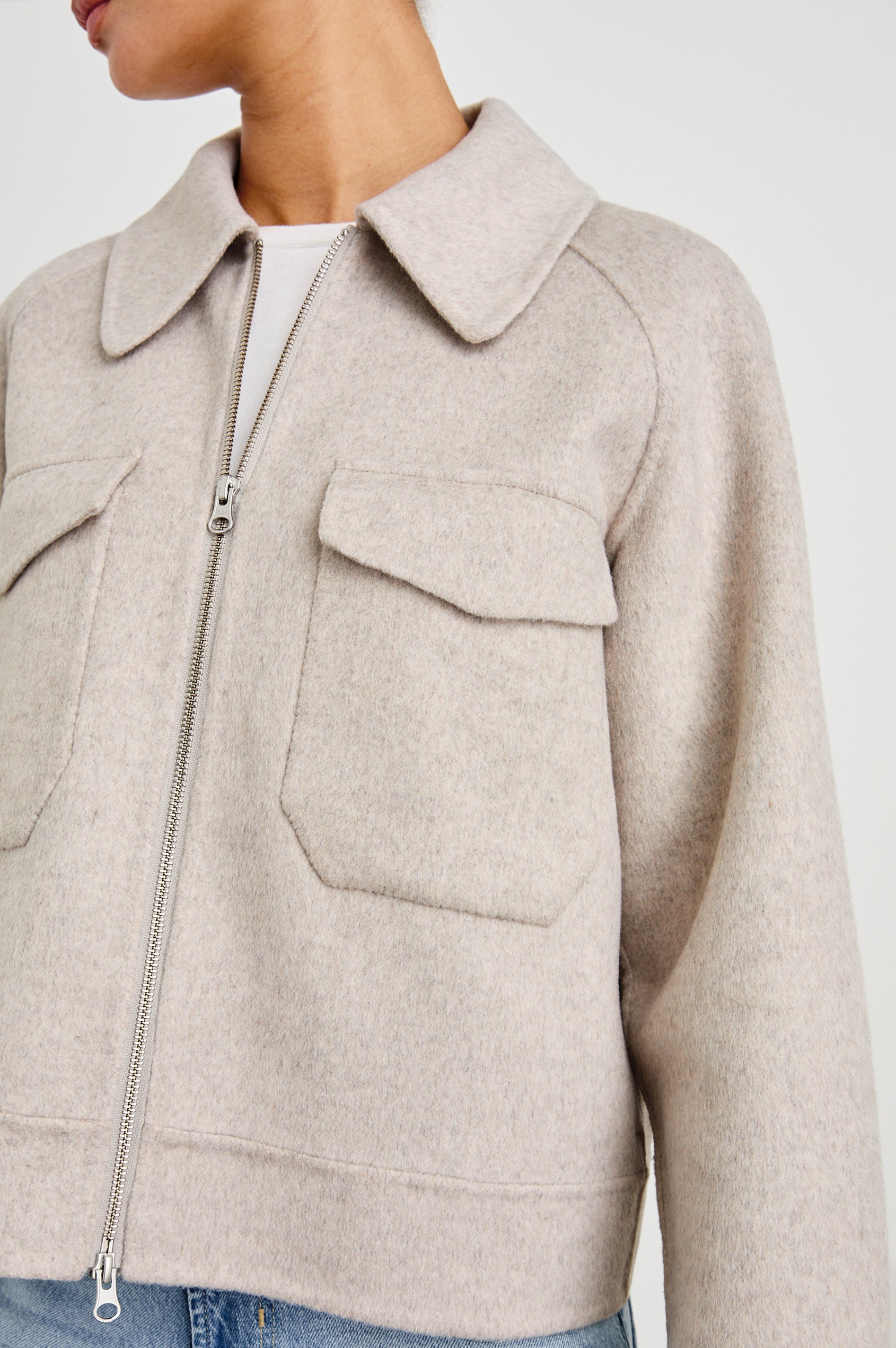 Cheyenne fitted wool jacket with oversized pockets and collar in Oatmeal - close up of details on model, fully zipped