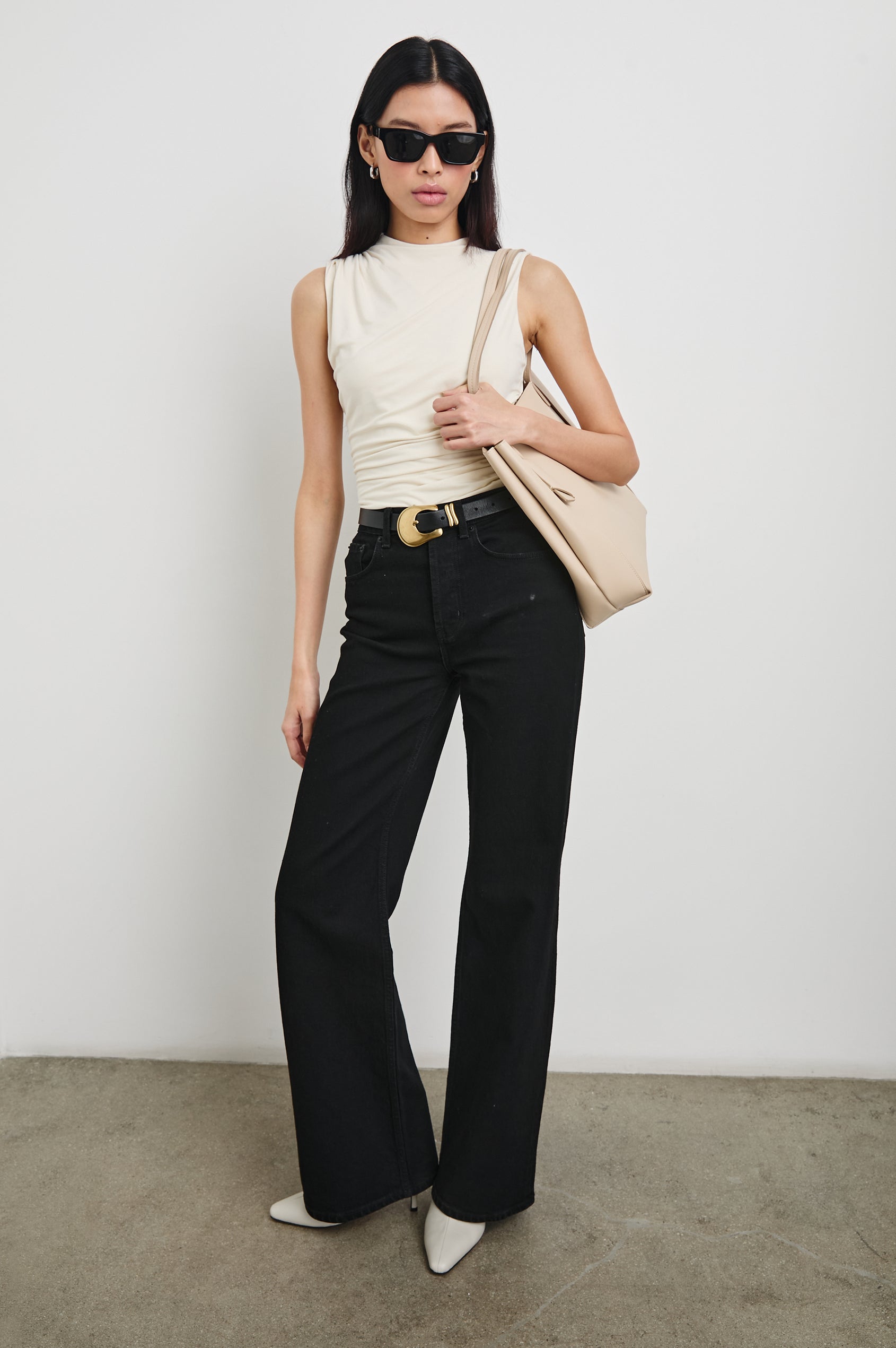 Christen Sleeveless Top with a Mock Neck and Ruching Along One Side Seam in Ivory Colorway - Front Full Body View Featured on Model