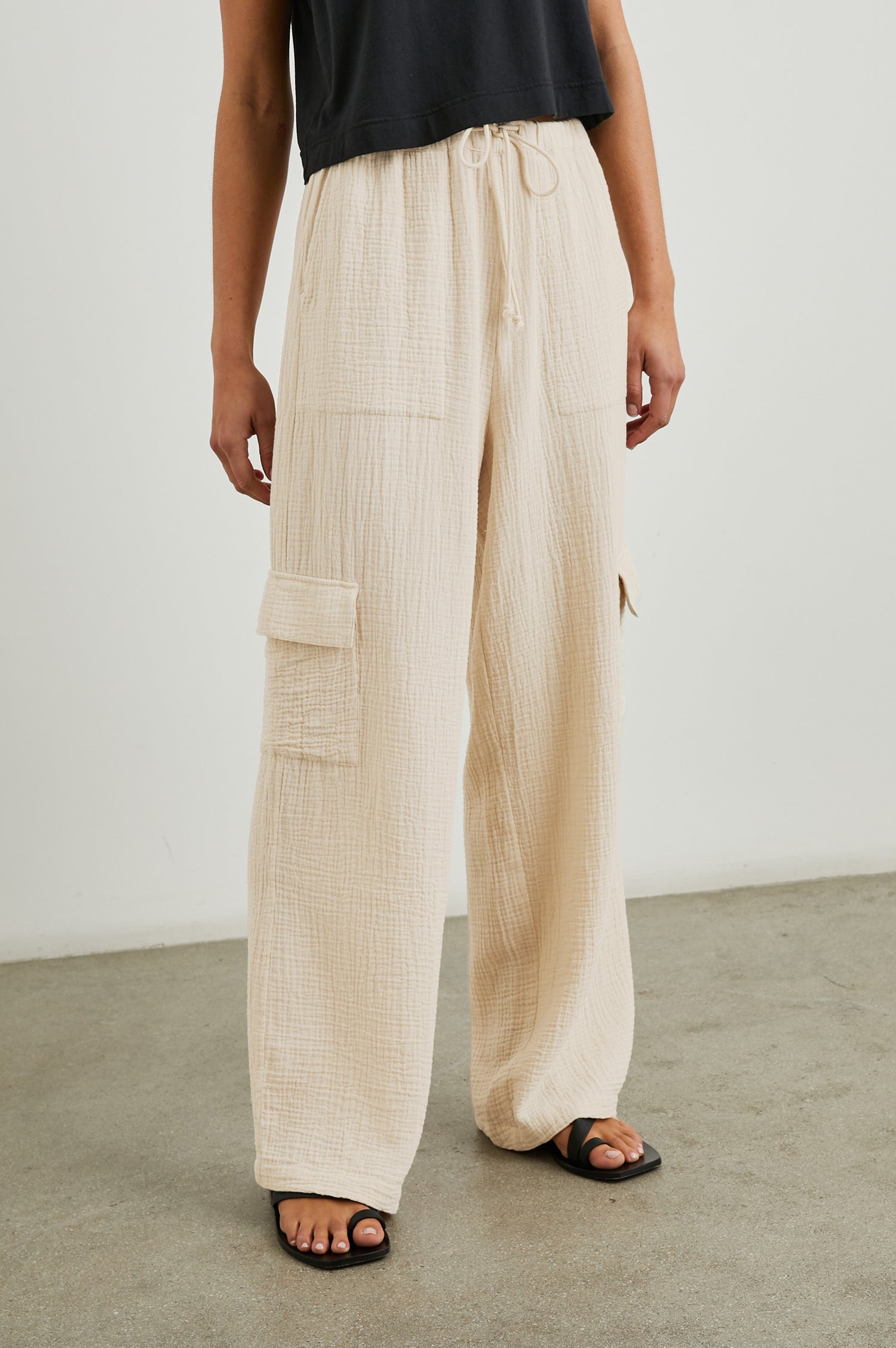 Christiano Pants with a Drawstring Waist, Two Front Pockets and Two Flap Side Pockets in Flax Colorway - Front View Featured on Model  