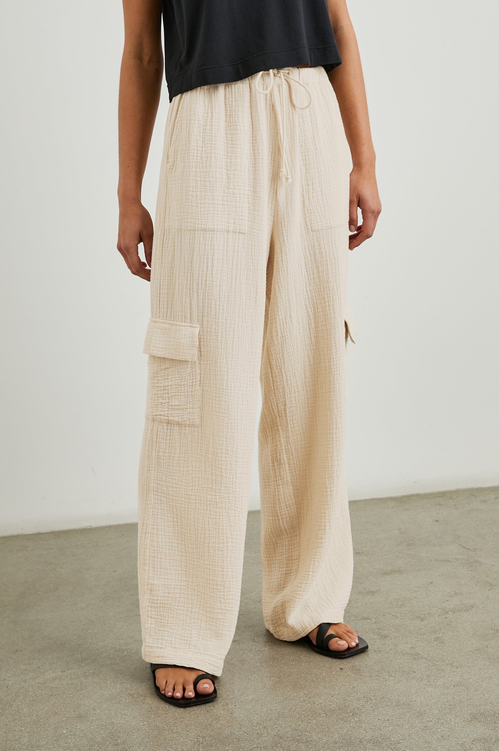 Christiano Pants with a Drawstring Waist, Two Front Pockets and Two Flap Side Pockets in Flax Colorway - Front View Featured on Model  