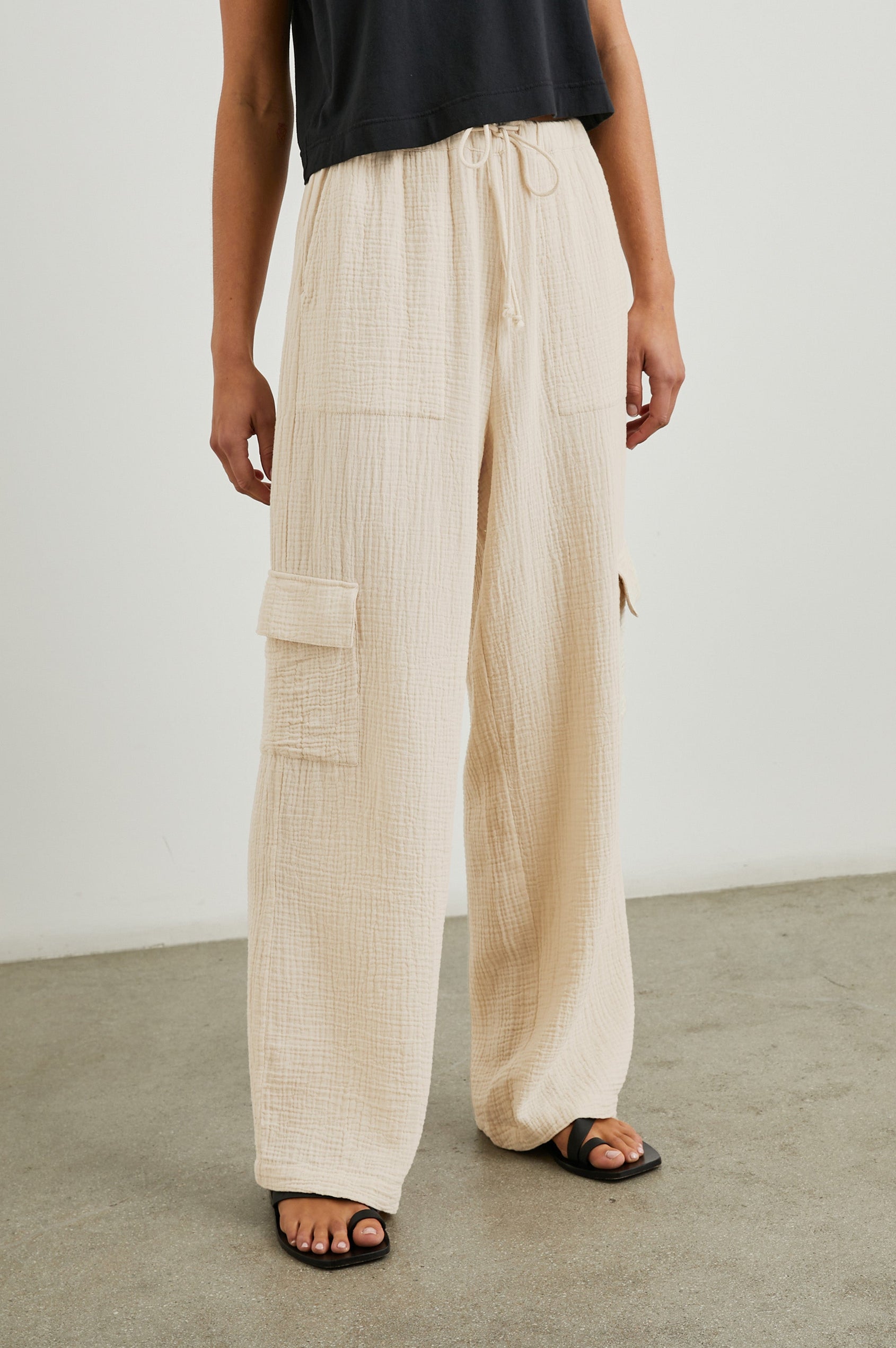 Christiano Pants with a Drawstring Waist, Two Front Pockets and Two Flap Side Pockets in Flax Colorway - Front View Featured on Model  