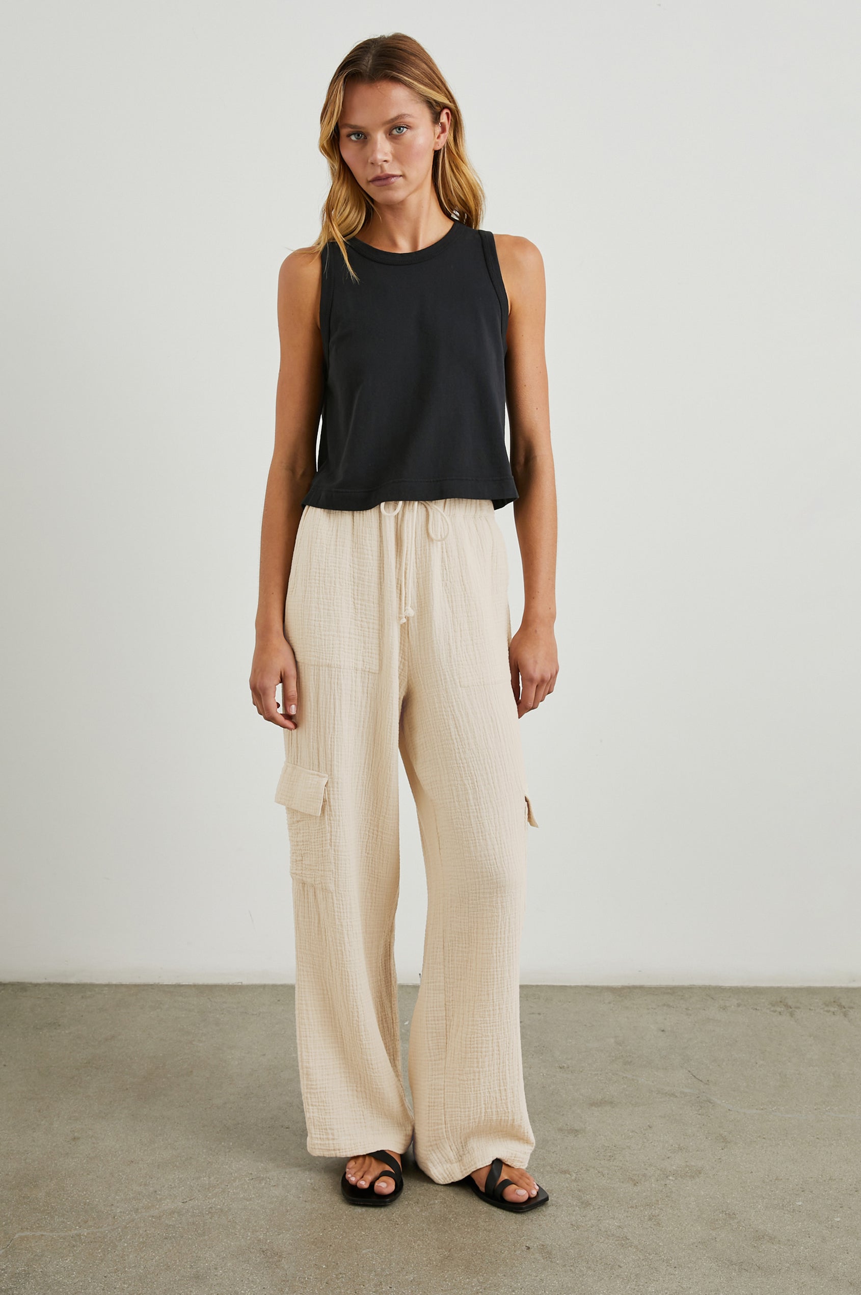 Christiano Pants with a Drawstring Waist, Two Front Pockets and Two Flap Side Pockets in Flax Colorway - Front Full Body View Featured on Model  