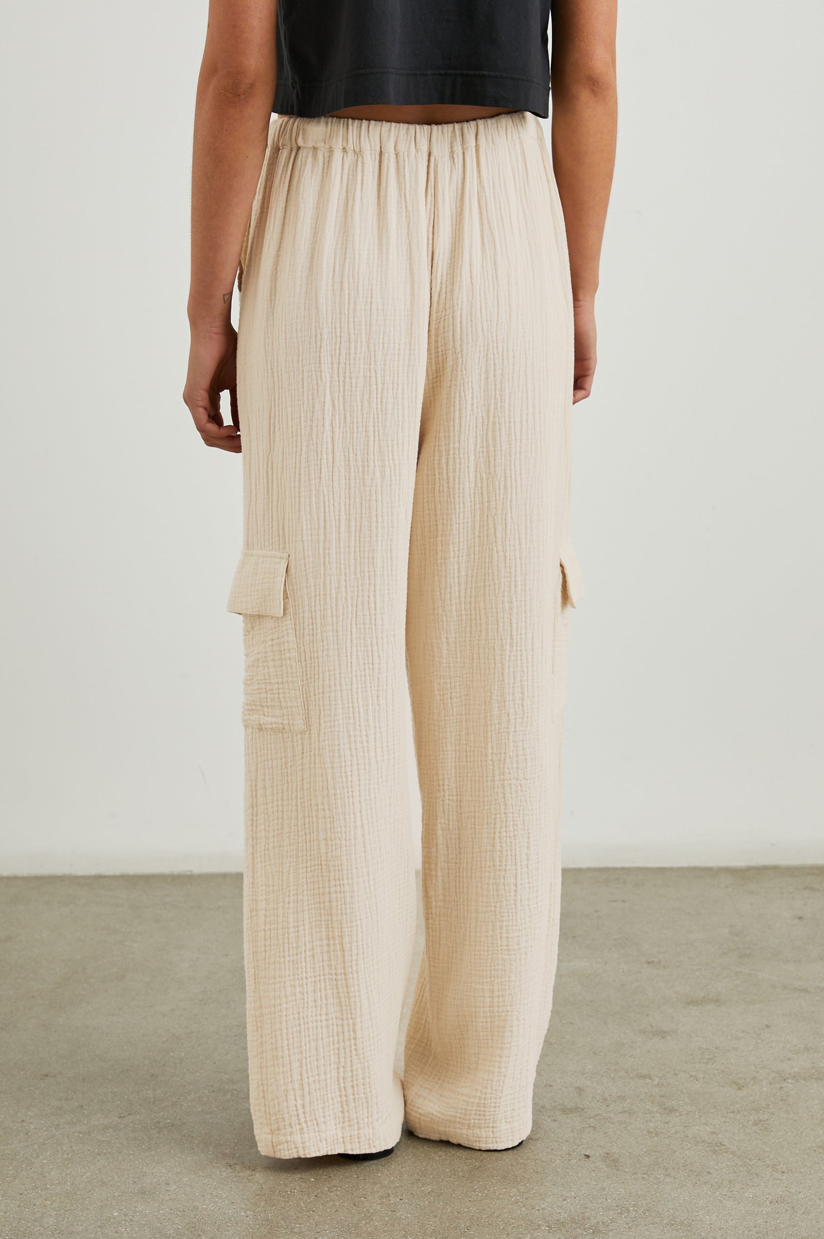 Christiano Pants with a Drawstring Waist, Two Front Pockets and Two Flap Side Pockets in Flax Colorway - Back View Featured on Model  