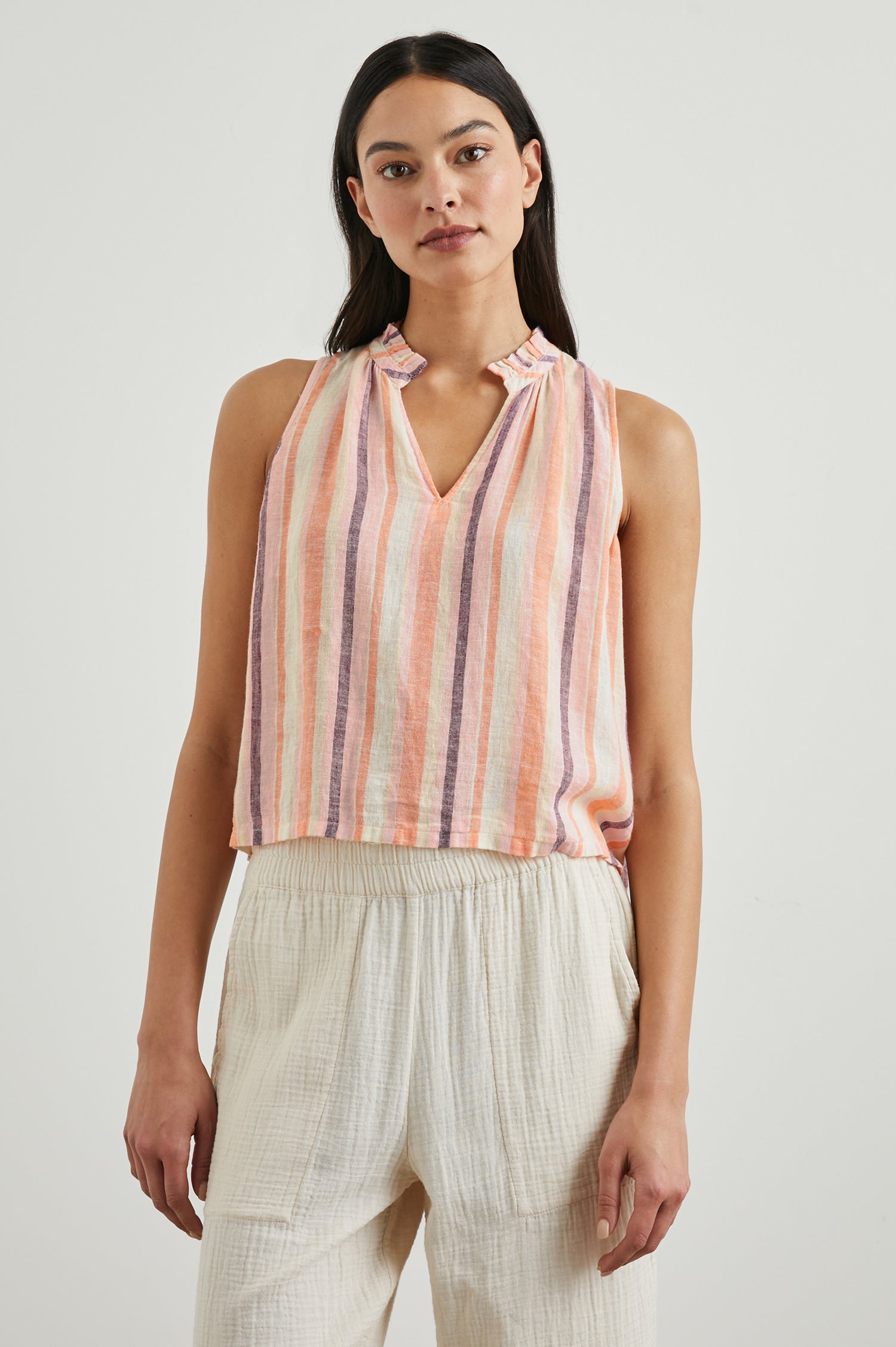 Christy Sleeveless Tank Top, with a V Neck and a Ruched Collar in Papaya Stripe Colorway, Vertical Stripes in Orange, Pink, Purple and Cream - Front View Featured on Model