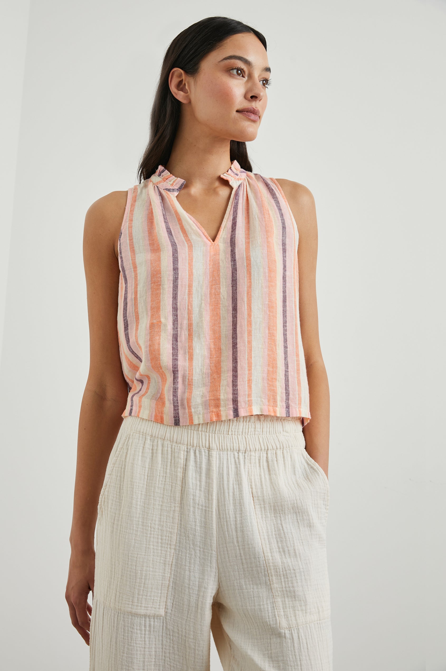 Christy Sleeveless Tank Top, with a V Neck and a Ruched Collar in Papaya Stripe Colorway, Vertical Stripes in Orange, Pink, Purple and Cream - Front View Featured on Model