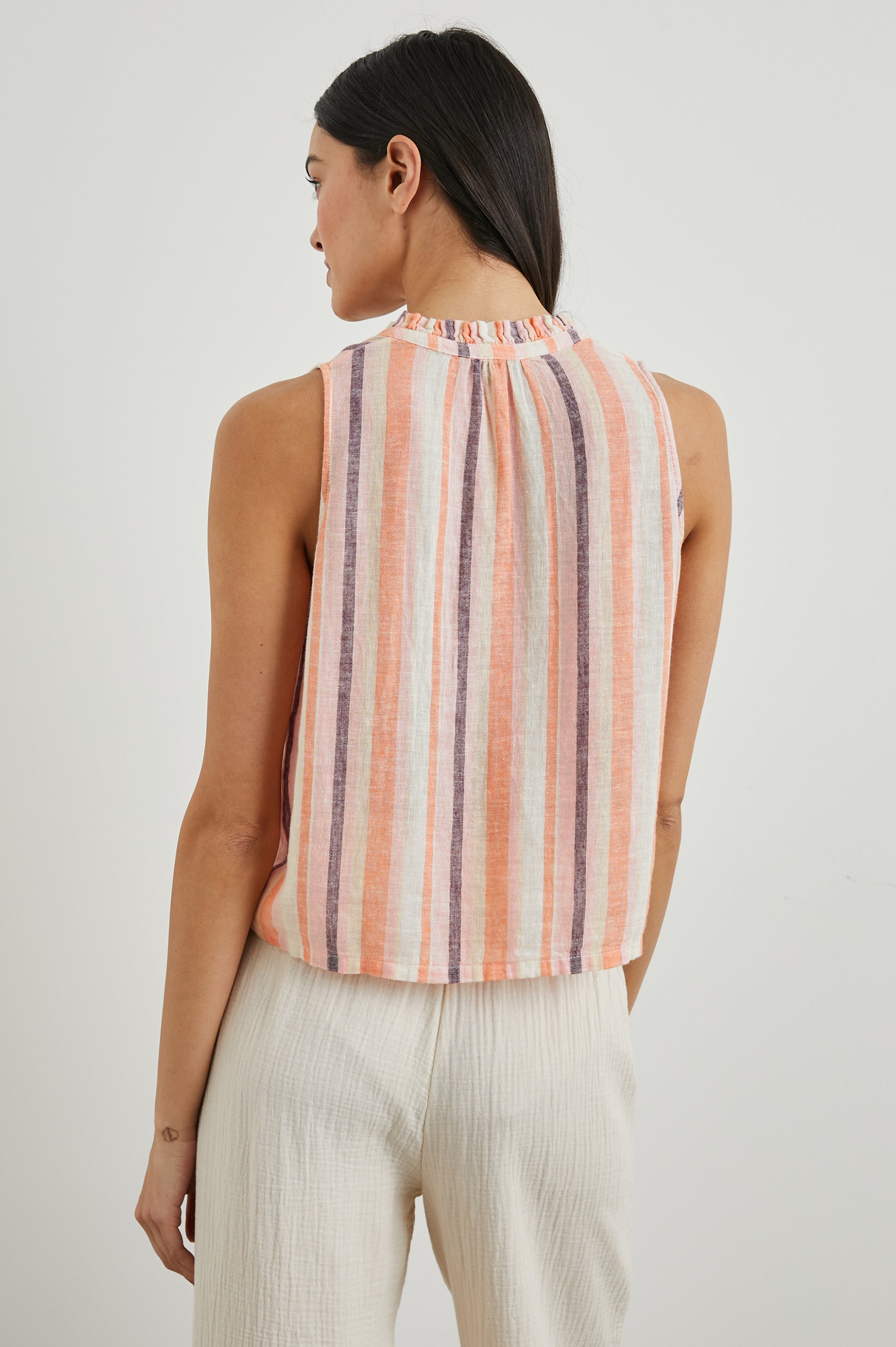 Christy Sleeveless Tank Top, with a V Neck and a Ruched Collar in Papaya Stripe Colorway, Vertical Stripes in Orange, Pink, Purple and Cream - Back View Featured on Model
