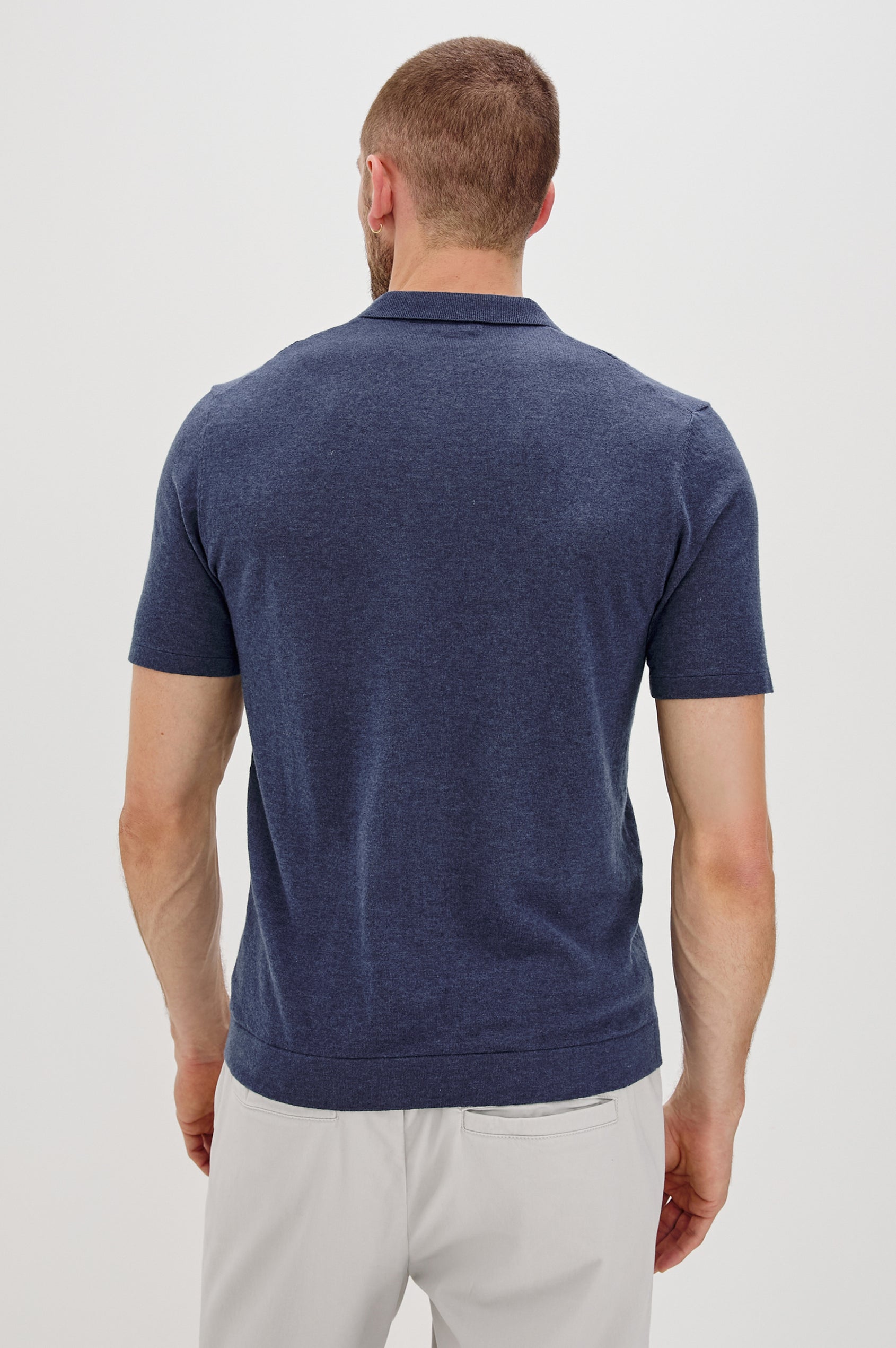 Cillian short sleeve cotton silk blend polo with three button placket and retro  front stripe details in Indigo Denim - back view on model 