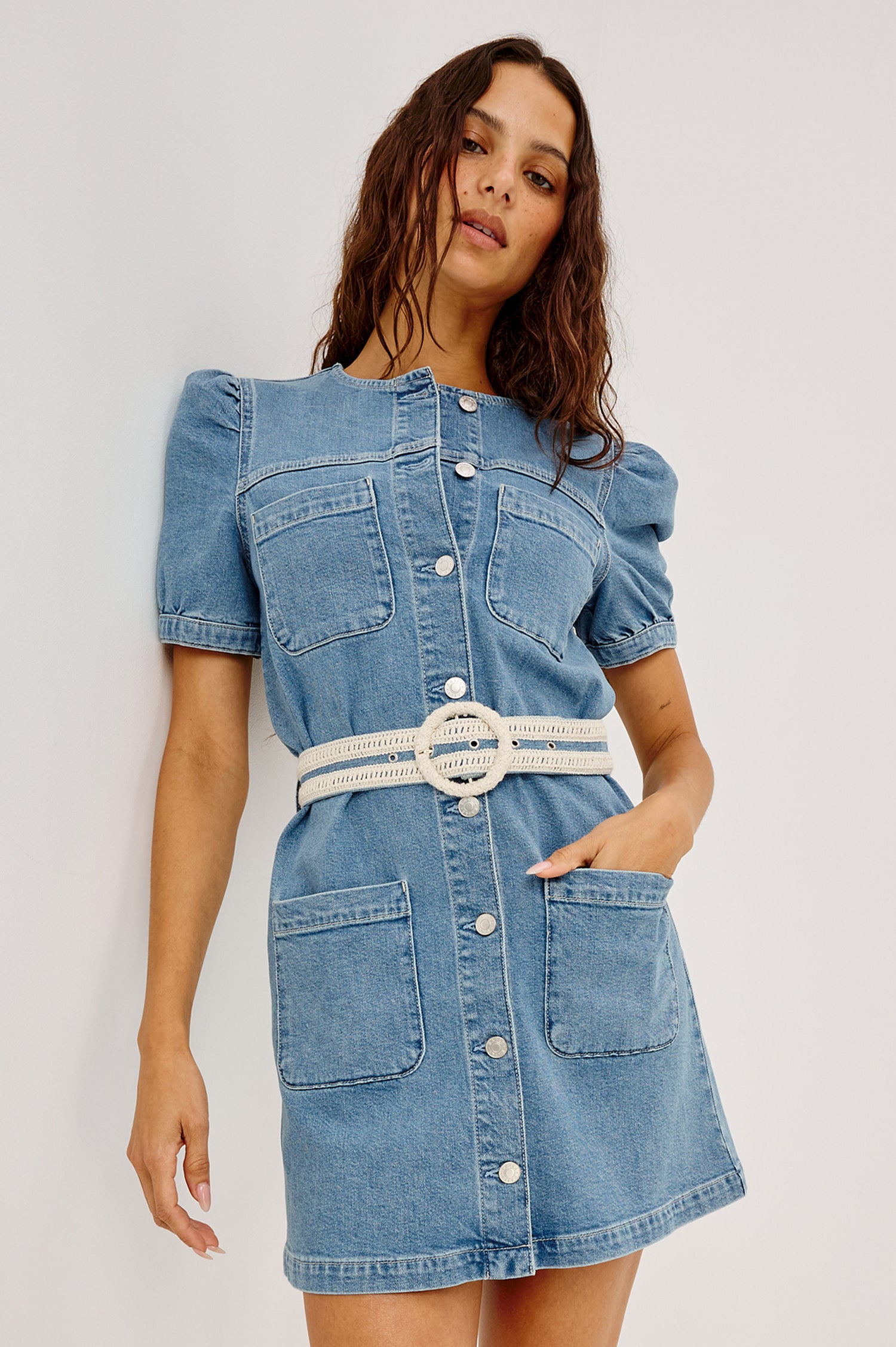 Clairemont Mini Shift Dress in Light Stretch Denim With Front Button Closures, Short Puff Sleeves, Front Patch Pockets, and an Adjustable Braided Belt in Sorrento Braided Colorway - Upper Body Front View Featured on Model