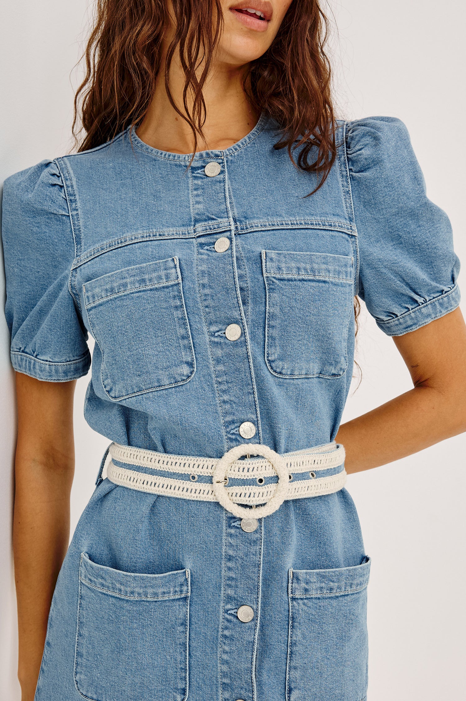 Clairemont Mini Shift Dress in Light Stretch Denim With Front Button Closures, Short Puff Sleeves, Front Patch Pockets, and an Adjustable Braided Belt in Sorrento Braided Colorway - Upper Body Front View Featured on Model