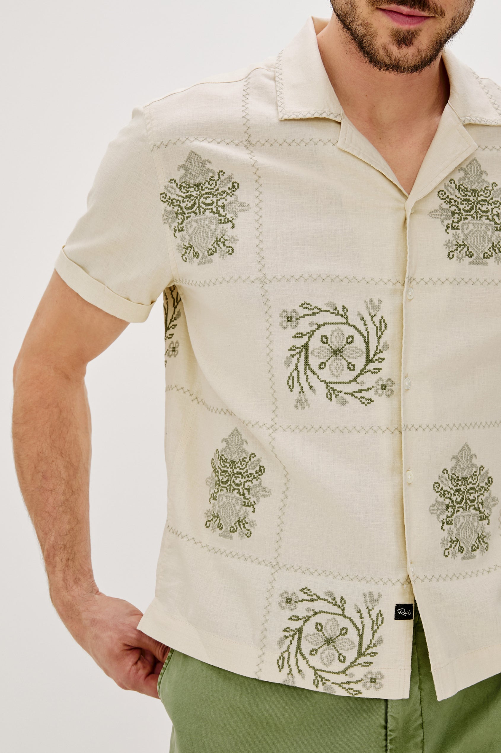 Clairo Button Front Shirt with a Relaxed Lapel, Cuffed Short Sleeves and Embroidery throughout in Cream Quilt Squares Colorway. Front Detail  View Shown on Model.