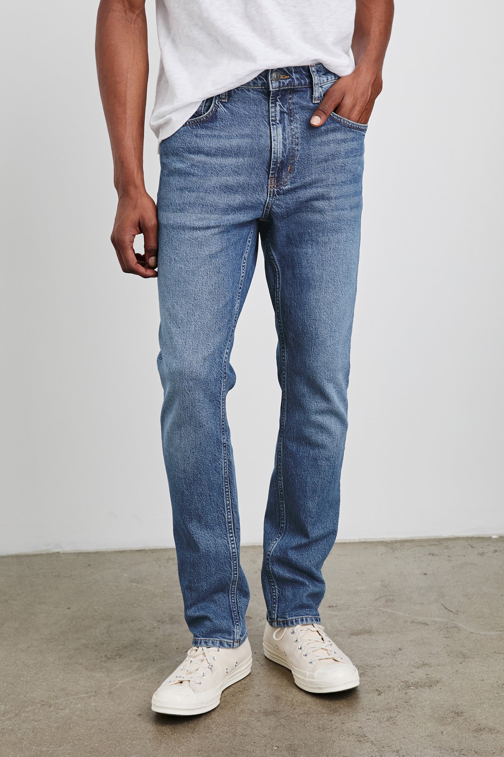 Clayton Slim Straight Jeans with Belt Loops, Two Front Pockets plus a Coin Pocket and Two Back Patch Pockets in Authentic 10 Year Colorway, a Blue - Front View Featured on Model