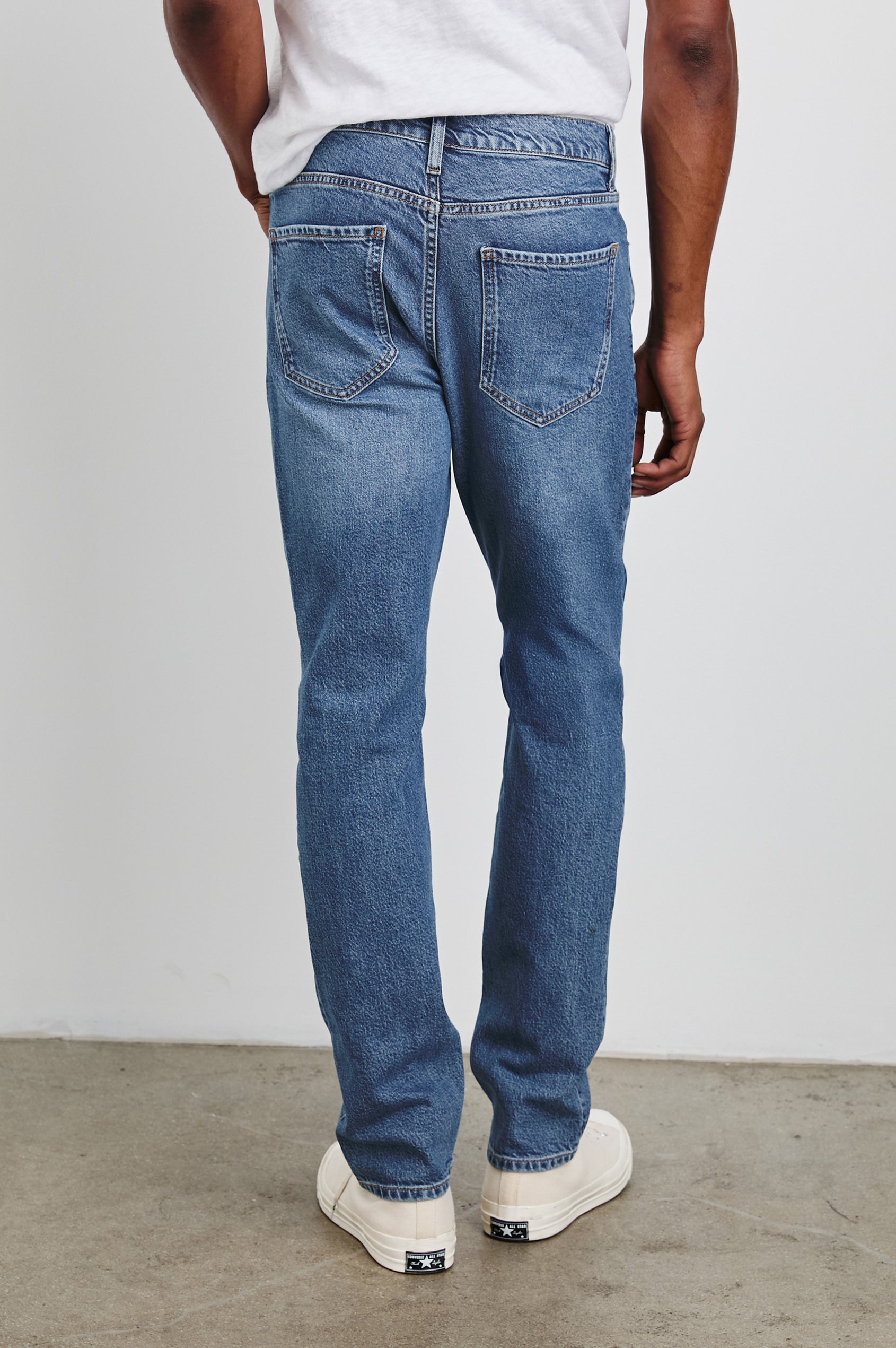 Clayton Slim Straight Jeans with Belt Loops, Two Front Pockets plus a Coin Pocket and Two Back Patch Pockets in Authentic 10 Year Colorway, a Blue - Back View Featured on Model