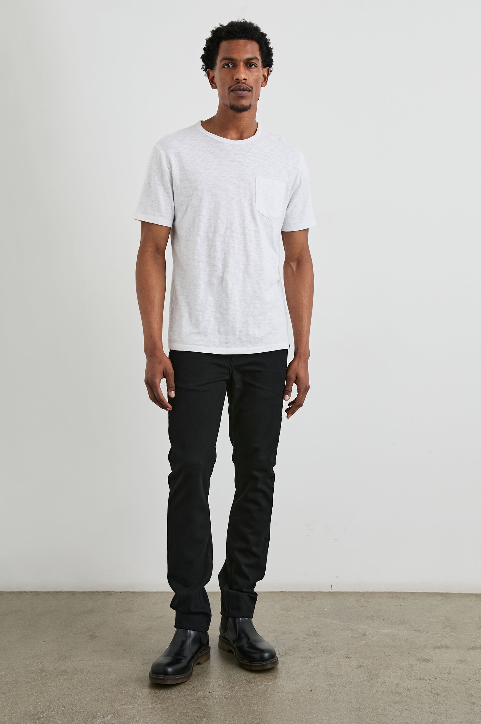 Clayton Slim Straight Jeans with Belt Loops, Two Front Pockets plus a Coin Pocket and Two Back Patch Pockets in Dark Black Colorway - Front Full Body View Featured on Model