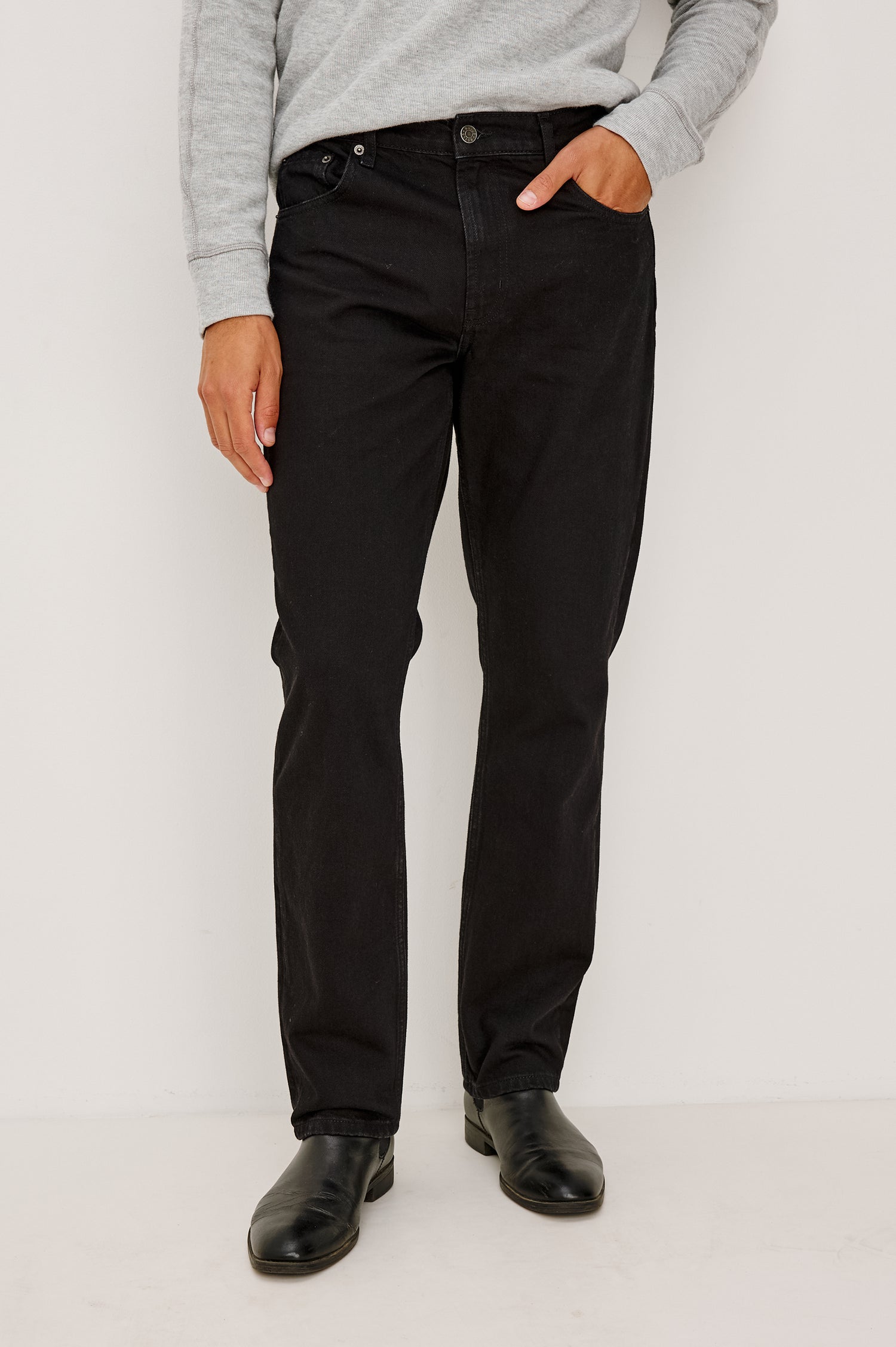 Clayton Slim Straight Jean With 5-Pocket Styling, Belt Loops, and Front Zip-Fly in Dark Black Colorway - Lower Body Front View Featured on Model