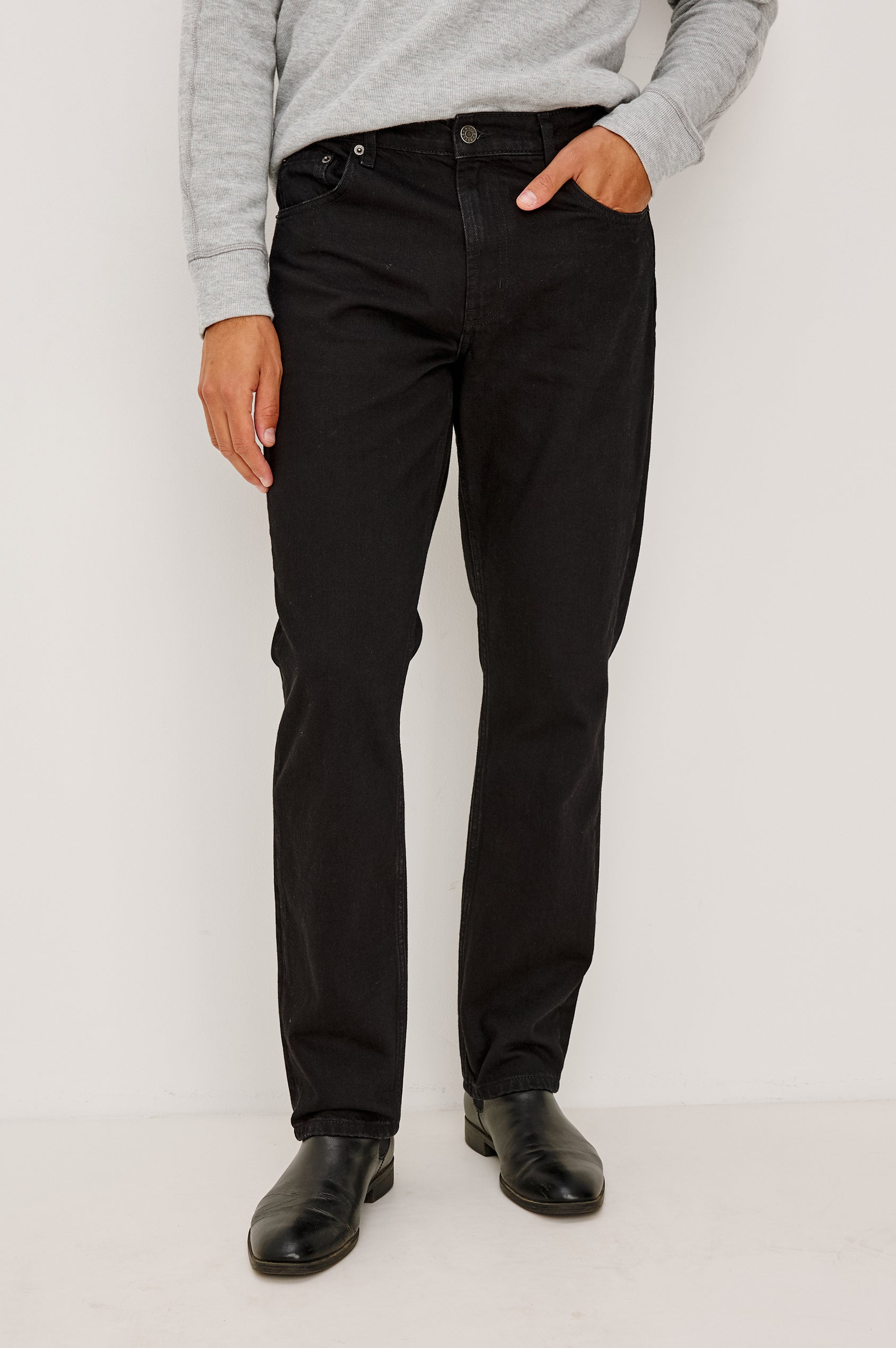 Clayton Slim Straight Jean With 5-Pocket Styling, Belt Loops, and Front Zip-Fly in Dark Black Colorway - Lower Body Front View Featured on Model