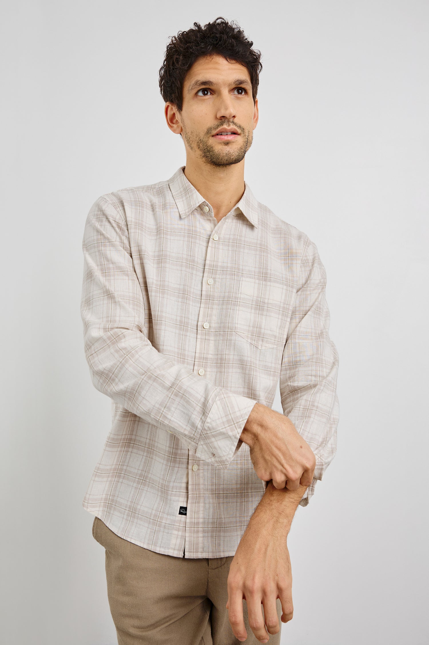 Clyde Collared Button Front Shirt with Long Sleeves and a Chest Pocket in Sea Oat White Colorway. Front View Shown on Model.