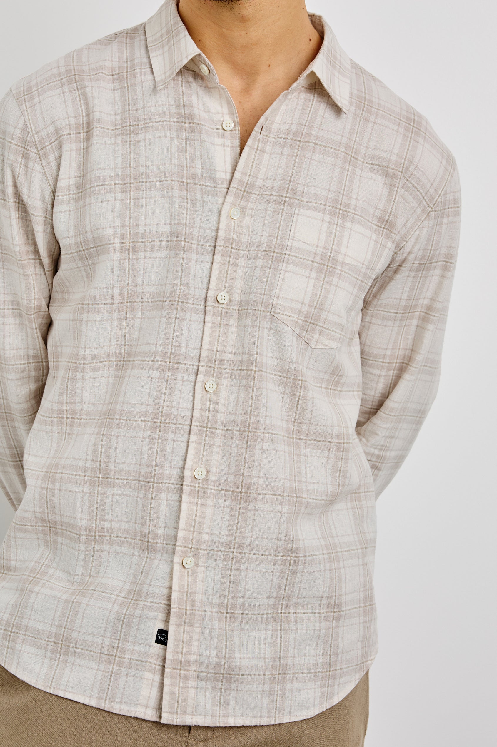 Clyde Collared Button Front Shirt with Long Sleeves and a Chest Pocket in Sea Oat White Colorway. Front View Shown on Model.