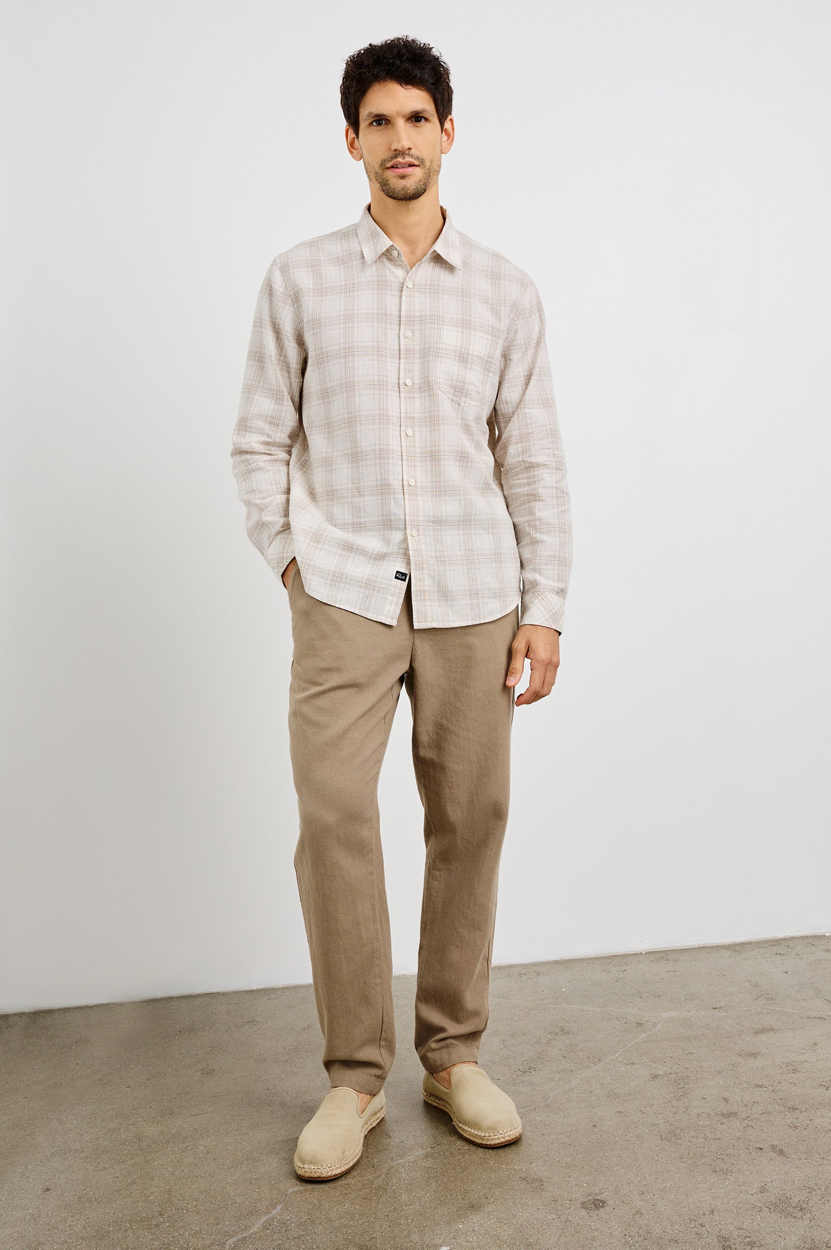 Clyde Collared Button Front Shirt with Long Sleeves and a Chest Pocket in Sea Oat White Colorway. Front View Shown on Model.