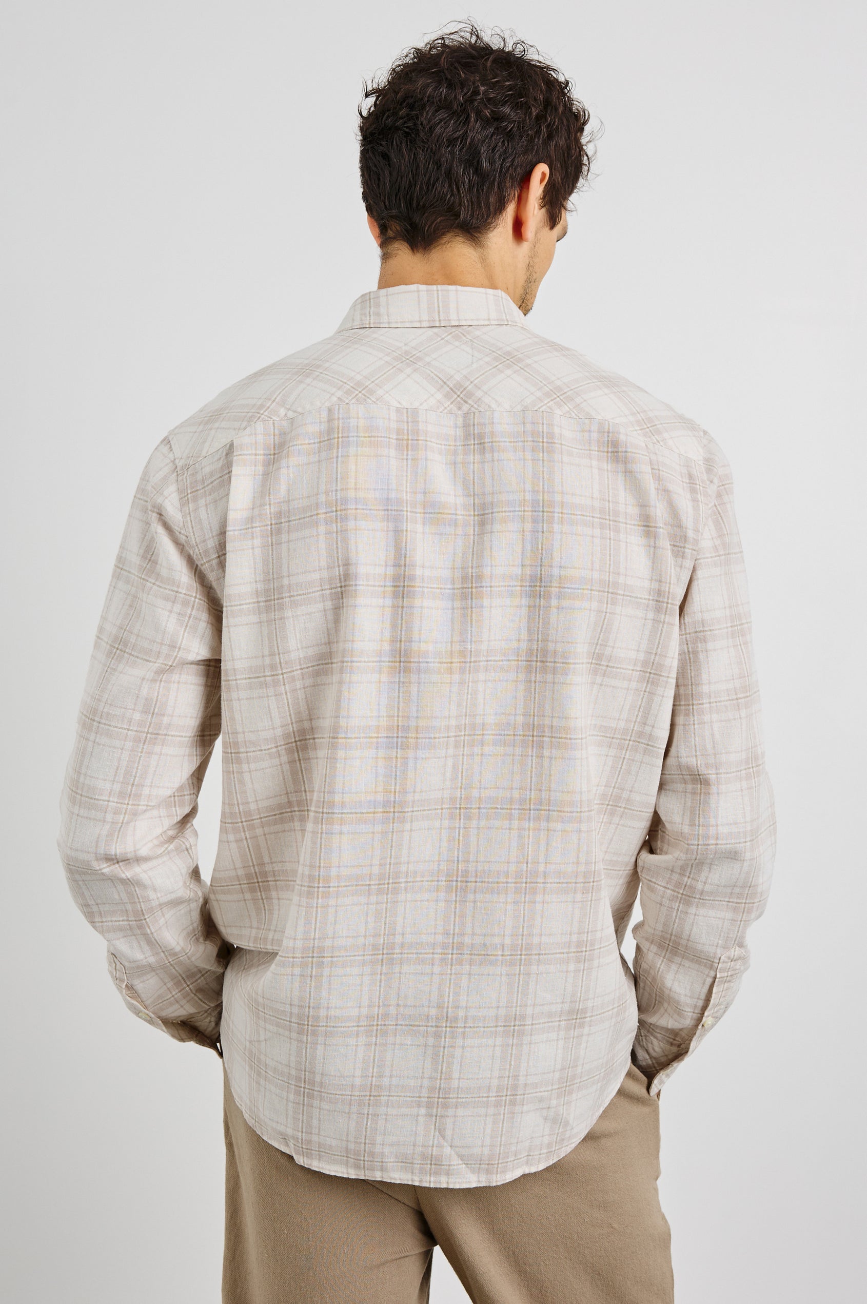 Clyde Collared Button Front Shirt with Long Sleeves and a Chest Pocket in Sea Oat White Colorway. Back View Shown on Model.