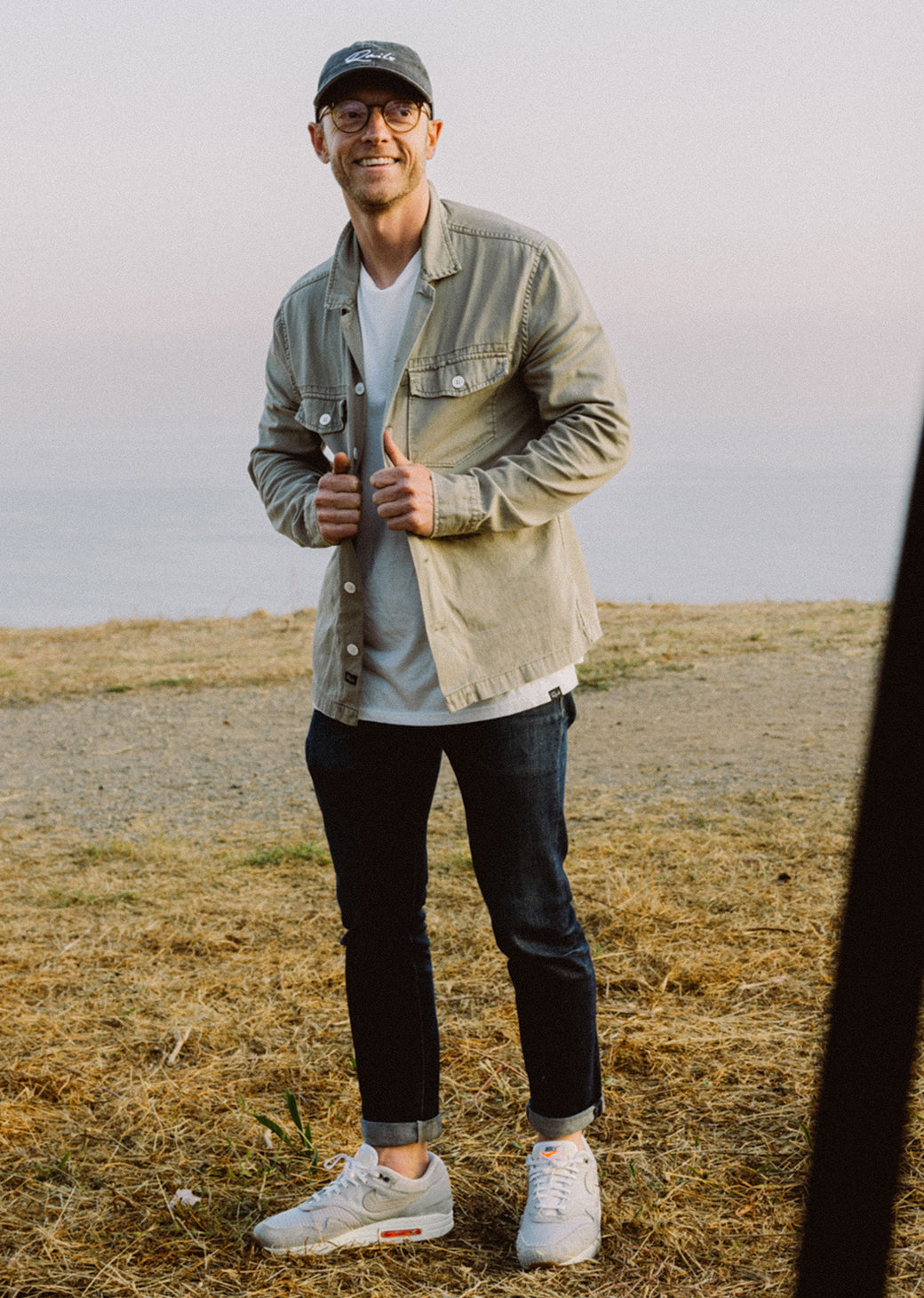 MALE WEARING KEROUAC SHIRT JACKET (LIGHT WEIGHT JACKET WITH WHITE BUTTON CLOSURE) IN COLOR NATURAL (TAN)