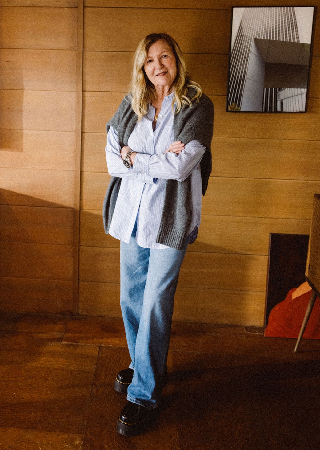 FEMALE WEARING ELSA SHIRT (LONG SLEEVE OVERSIDED BUTTON UP SHIRT) IN COLOR OXFORD WHITE STRIPE (LIGHT BLUE WITH WHITE VERTICAL STRIPES) AND GETTY WIDE LEG JEANS IN COLOR TIDAL WAVE (LIGHT WASH DENIM)