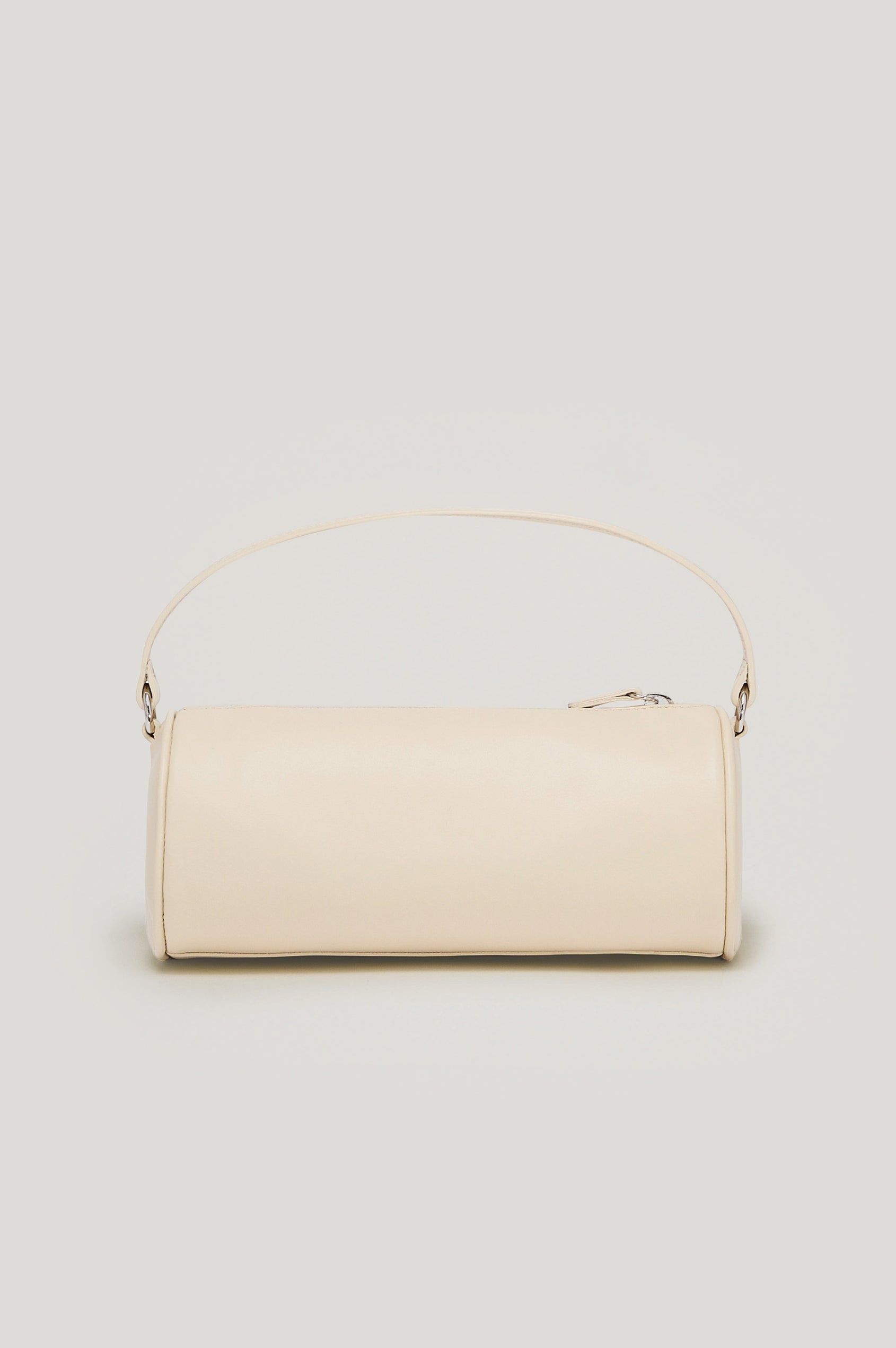 The Como is a mini barrel bag, made from smooth leather with a fixed top strap, a removable and adjustable buckled crossbody strap, a top zip, a side-embossed logo, and a branded interior label, in Bone Leather colorway. Front view featured.