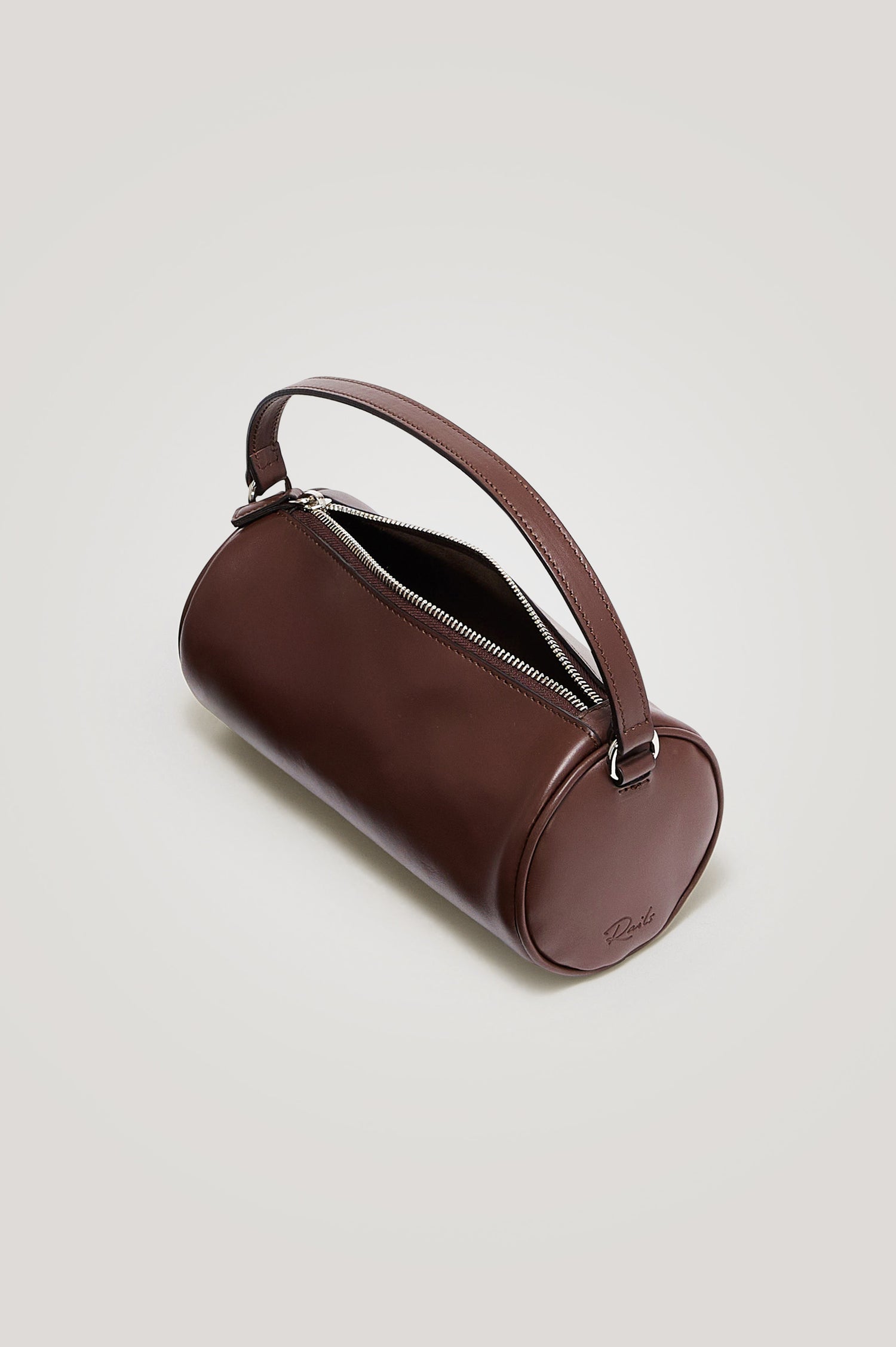 Como Mini Barrel Bag in Italian Leather With Fixed Top Strap, Removable and Adjustable Buckled Crossbody Strap, Top Zipper, Side-Embossed Logo, Branded Interior Label in Espresso Colorway - Top View Featured