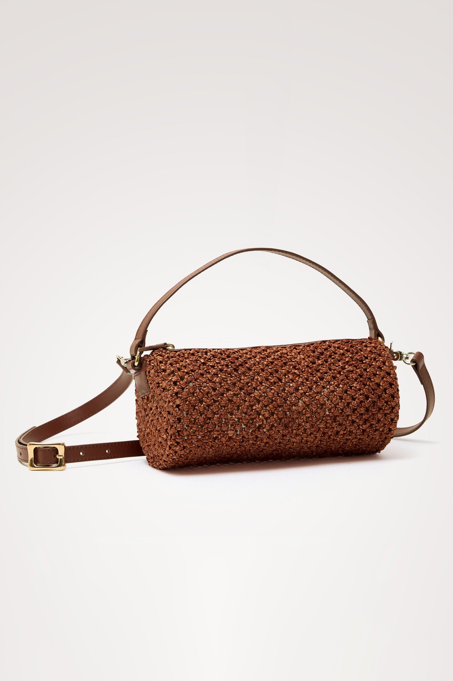 Como Mini Barrel Bag in Woven Raffia With Top Strap, Removable and Adjustable Crossbody Strap, and Top Zip in Cognac Raffia Colorway - Top View Featured