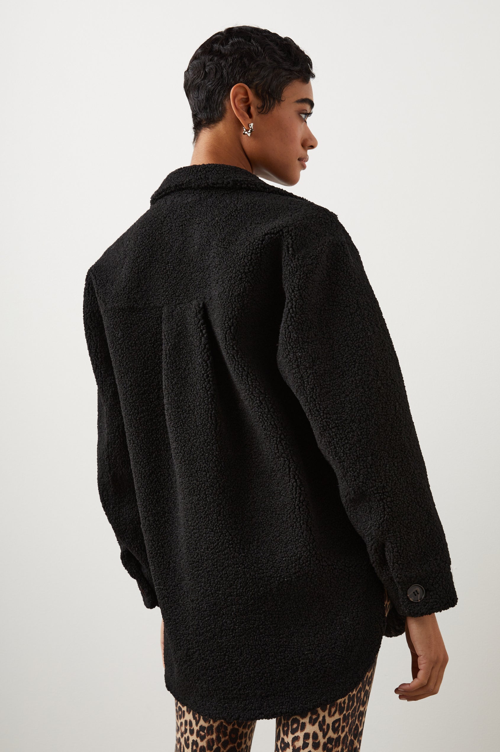 Connie Fleece Shirt Jacket with Button Closure, Two Front Pockets and Two Chest Patch Pockets in Black Teddy Colorway - Back View Featured on Model 