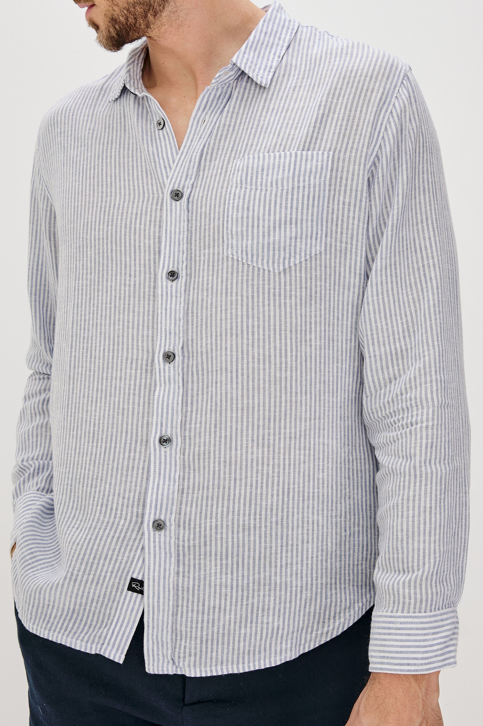 Connor Long-Sleeve Button Up with a Chest Patch Pocket in Denim White Railroad Colorway, Vertical Stripes - Front View Featured on Model