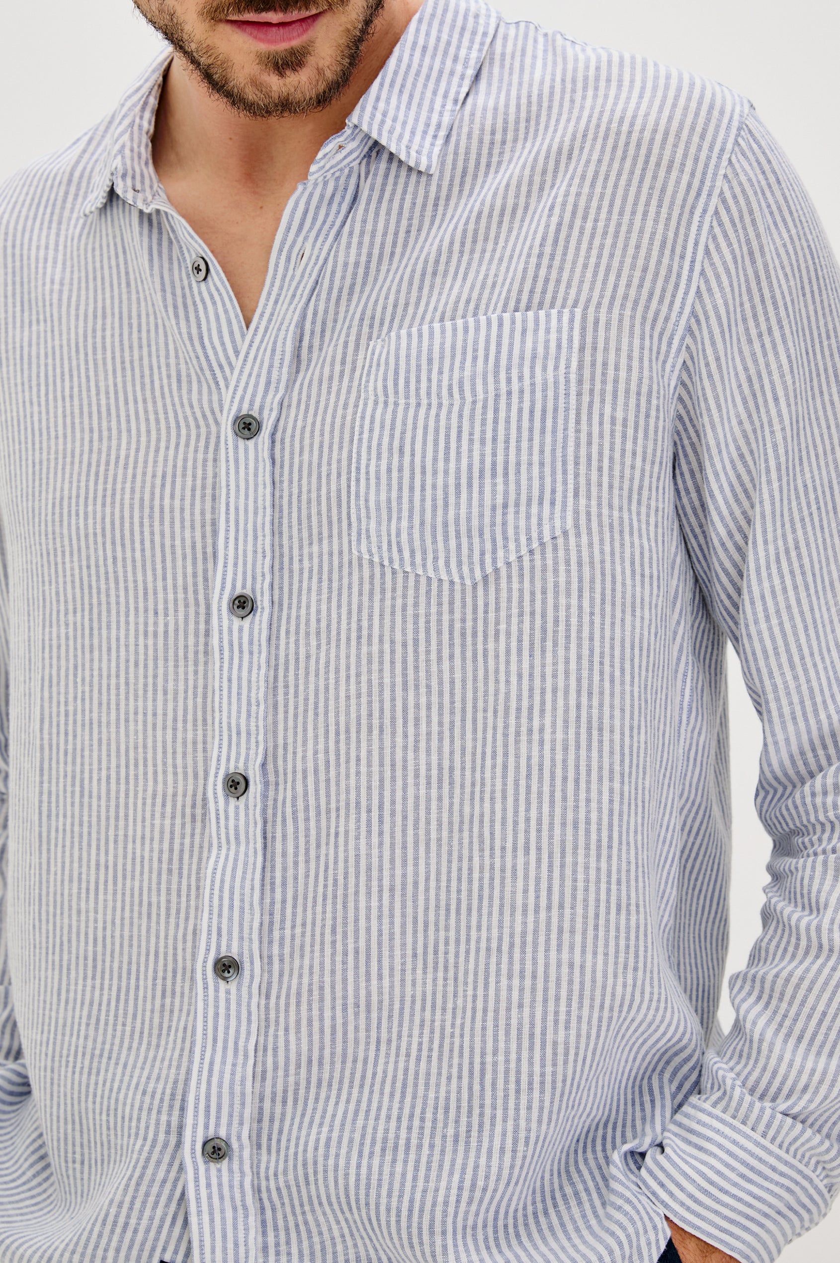 Connor Long-Sleeve Button Up with a Chest Patch Pocket in Denim White Railroad Colorway, Vertical Stripes - Front View Featured on Model
