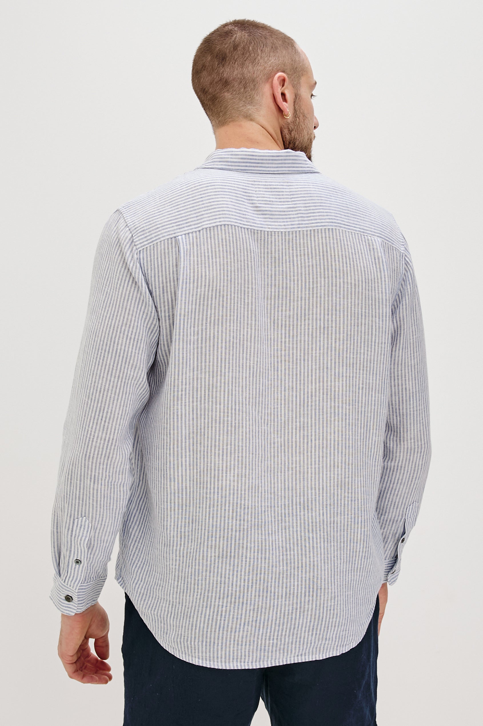 Connor Long-Sleeve Button Up with a Chest Patch Pocket in Denim White Railroad Colorway, Vertical Stripes - Back View Featured on Model