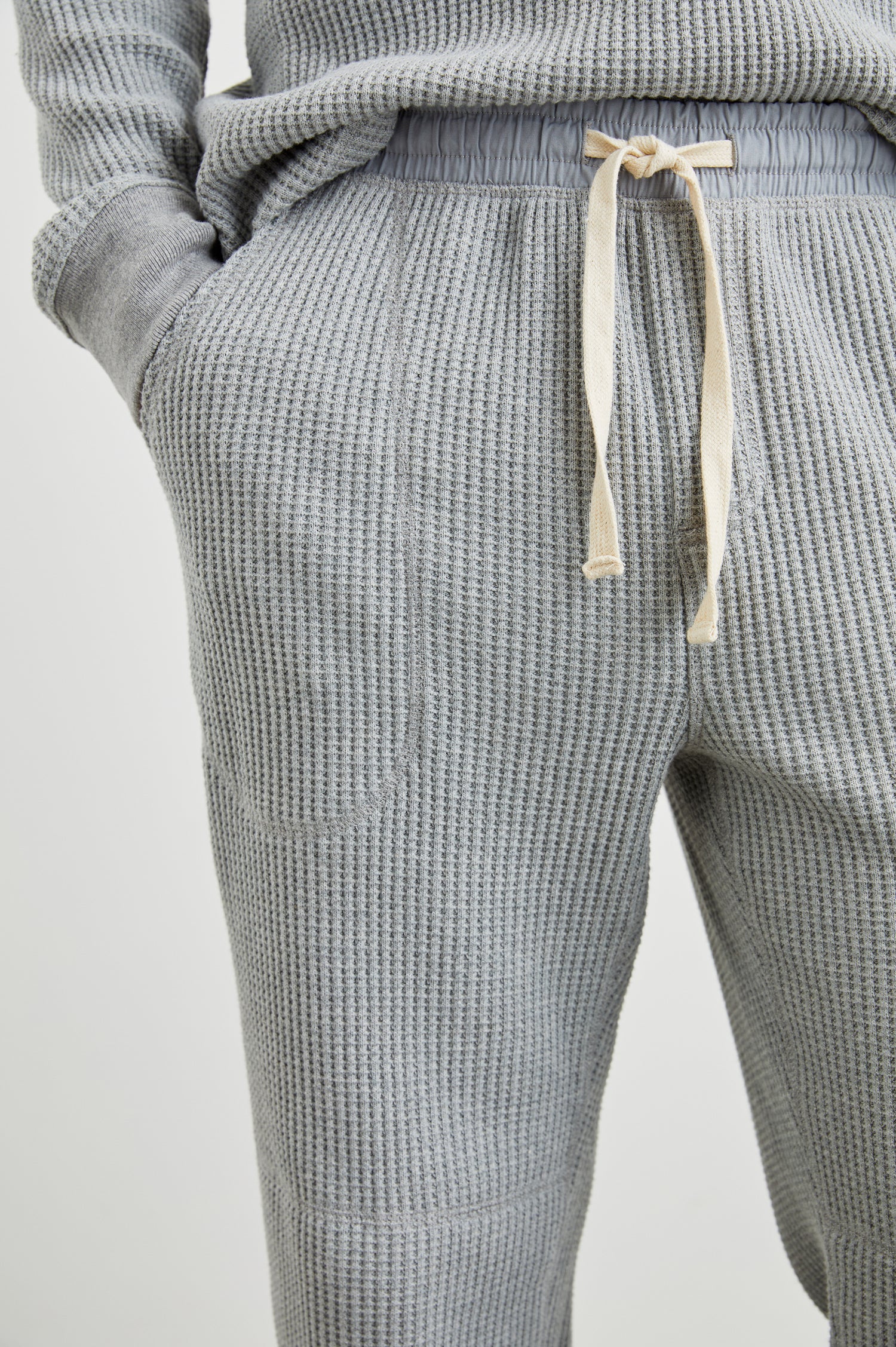 Cooper Waffle Thermal Pants with an Elastic Drawstring Waist, Two Teardrop Front Pockets, Two Back Welt Pockets, Reinforced Knee Patches and Elastic Cuffs in Heather Grey Colorway - Front View Featured on Model