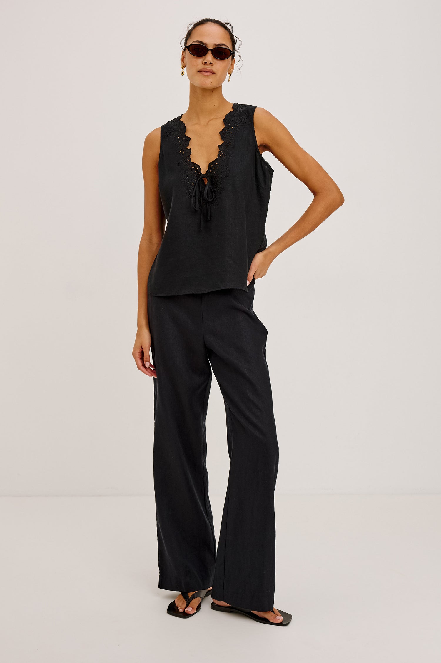 Cornelia Sleeveless Top in Heavy Linen With Embroidered Deep V-Neckline and Keyhole Self-Ties in Black Colorway - Full Body Front View Featured on Model