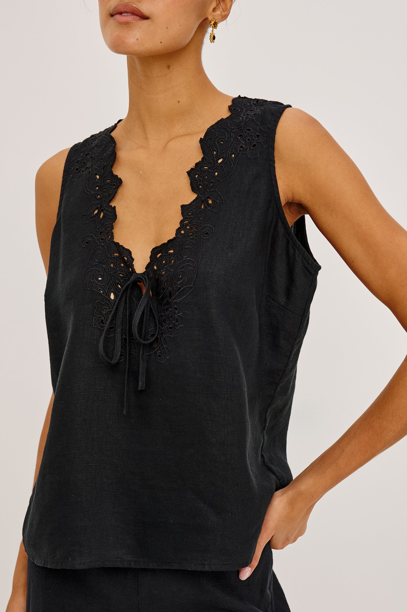 Cornelia Sleeveless Top in Heavy Linen With Embroidered Deep V-Neckline and Keyhole Self-Ties in Black Colorway - Upper Body Front View Featured on Model