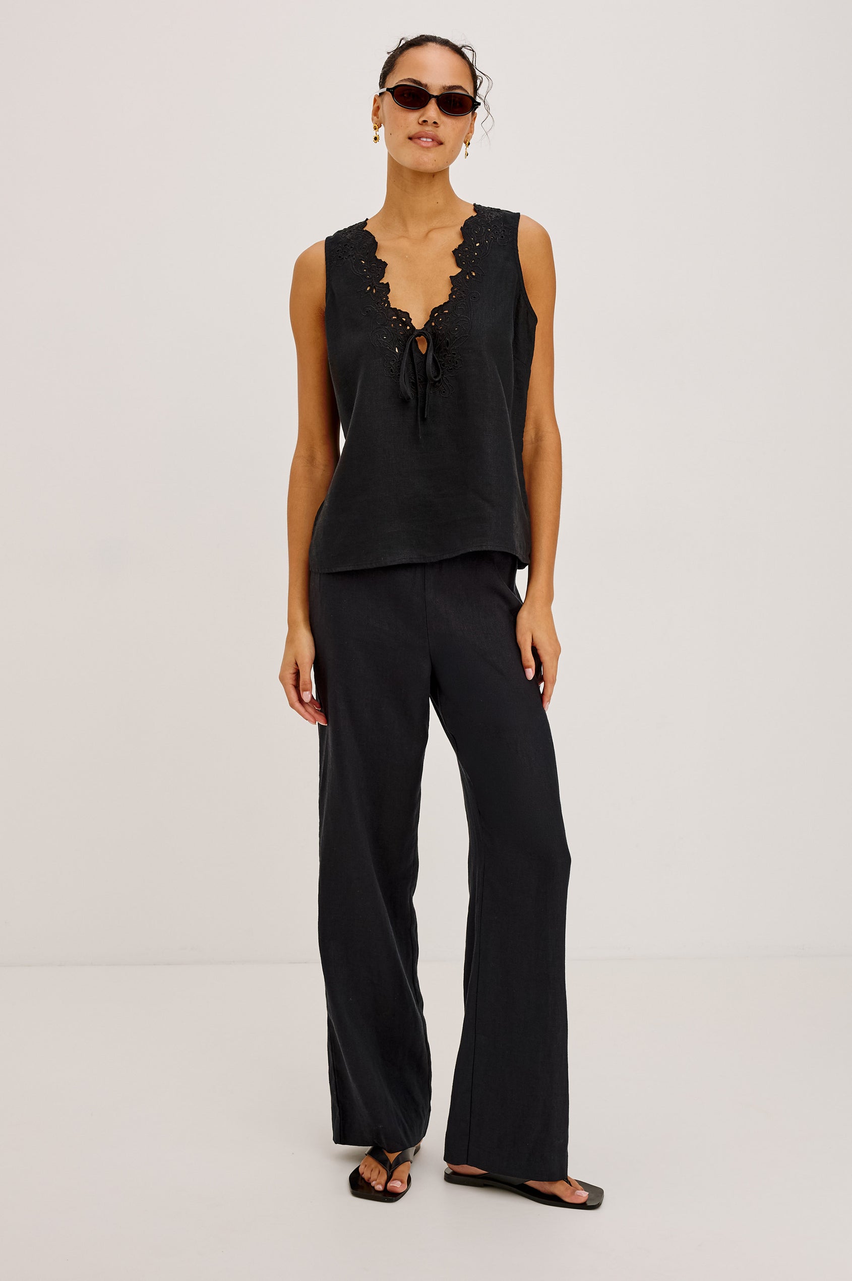 Cornelia Sleeveless Top in Heavy Linen With Embroidered Deep V-Neckline and Keyhole Self-Ties in Black Colorway - Full Body Front View Featured on Model
