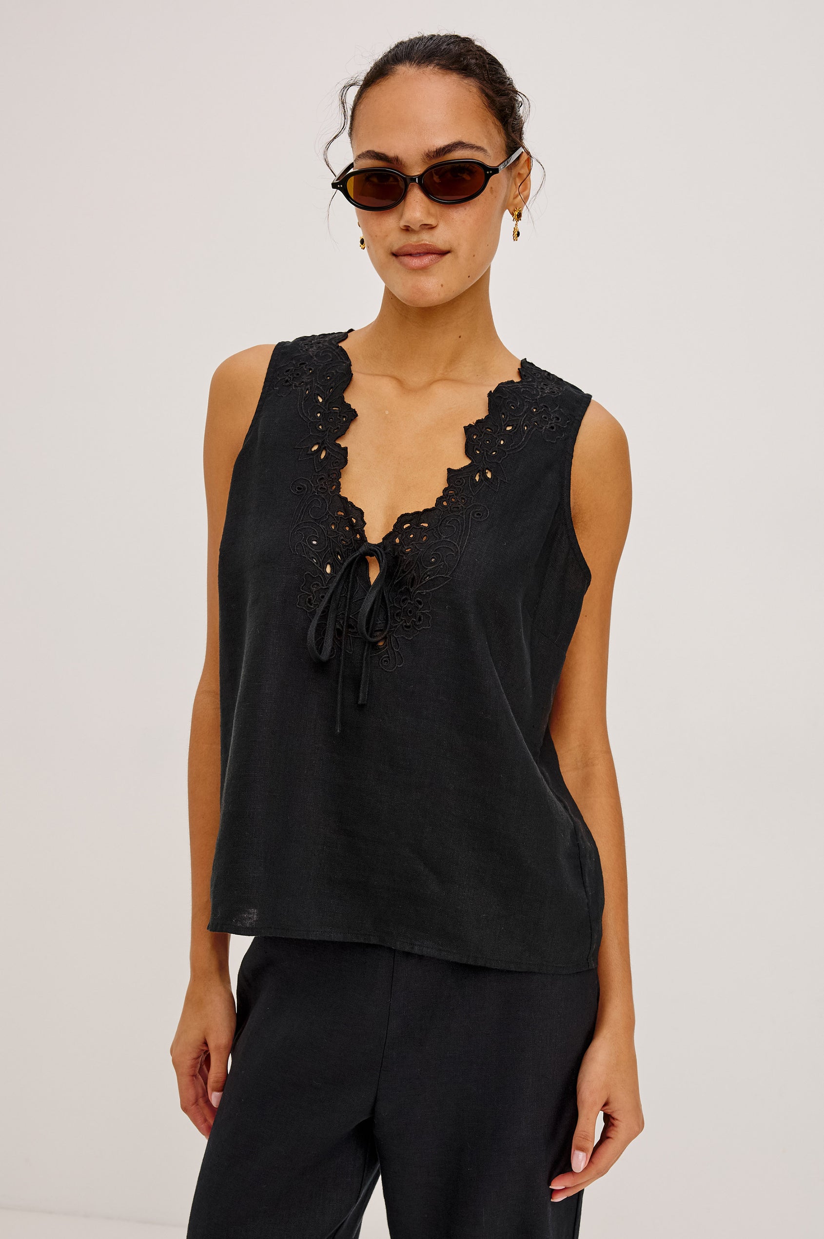 Cornelia Sleeveless Top in Heavy Linen With Embroidered Deep V-Neckline and Keyhole Self-Ties in Black Colorway - Upper Body Front View Featured on Model