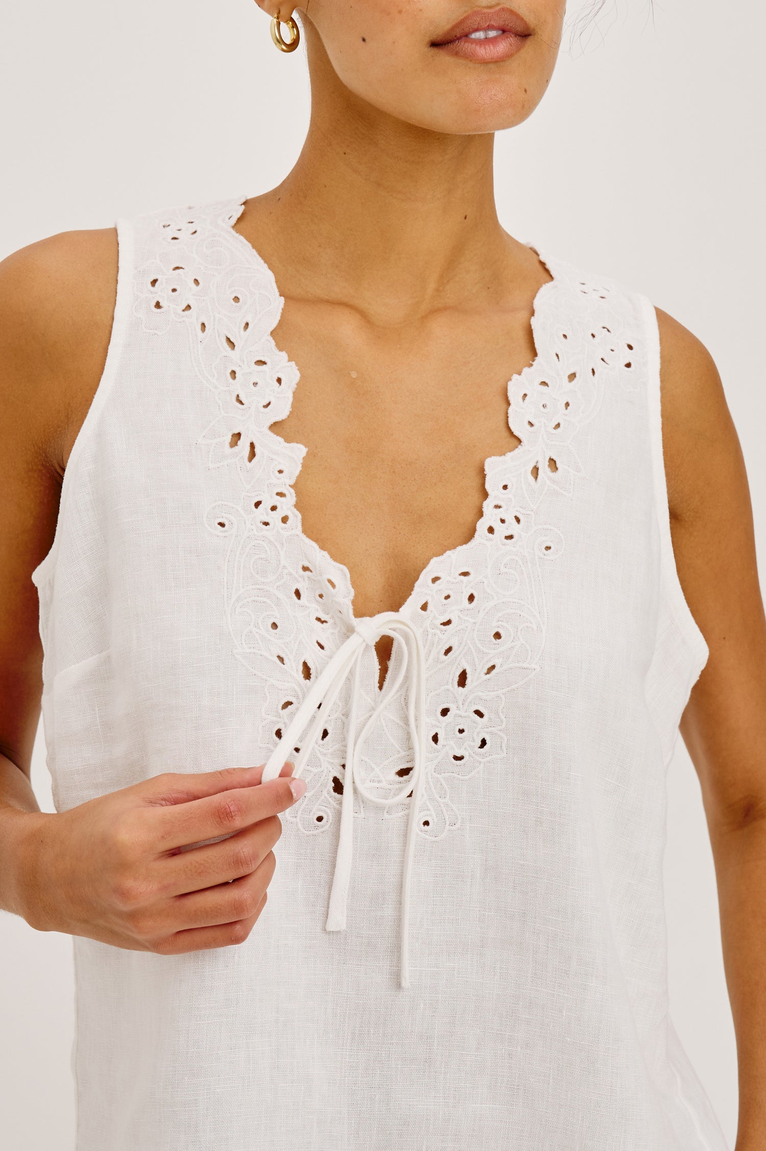 Cornelia Sleeveless Top in Heavy Linen With Embroidered Deep V-Neckline and Keyhole Self-Ties in White Colorway - Upper Body Front View Featured on Model